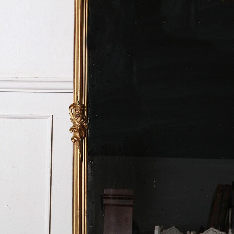Large French carved gilt-framed Louis XV style mirror with original shaped-beveled glass. Lovely proportions and scale; suitable to place on the floor as a full-length mirror or above a console, mantle ,etc. Beautiful carved details and an