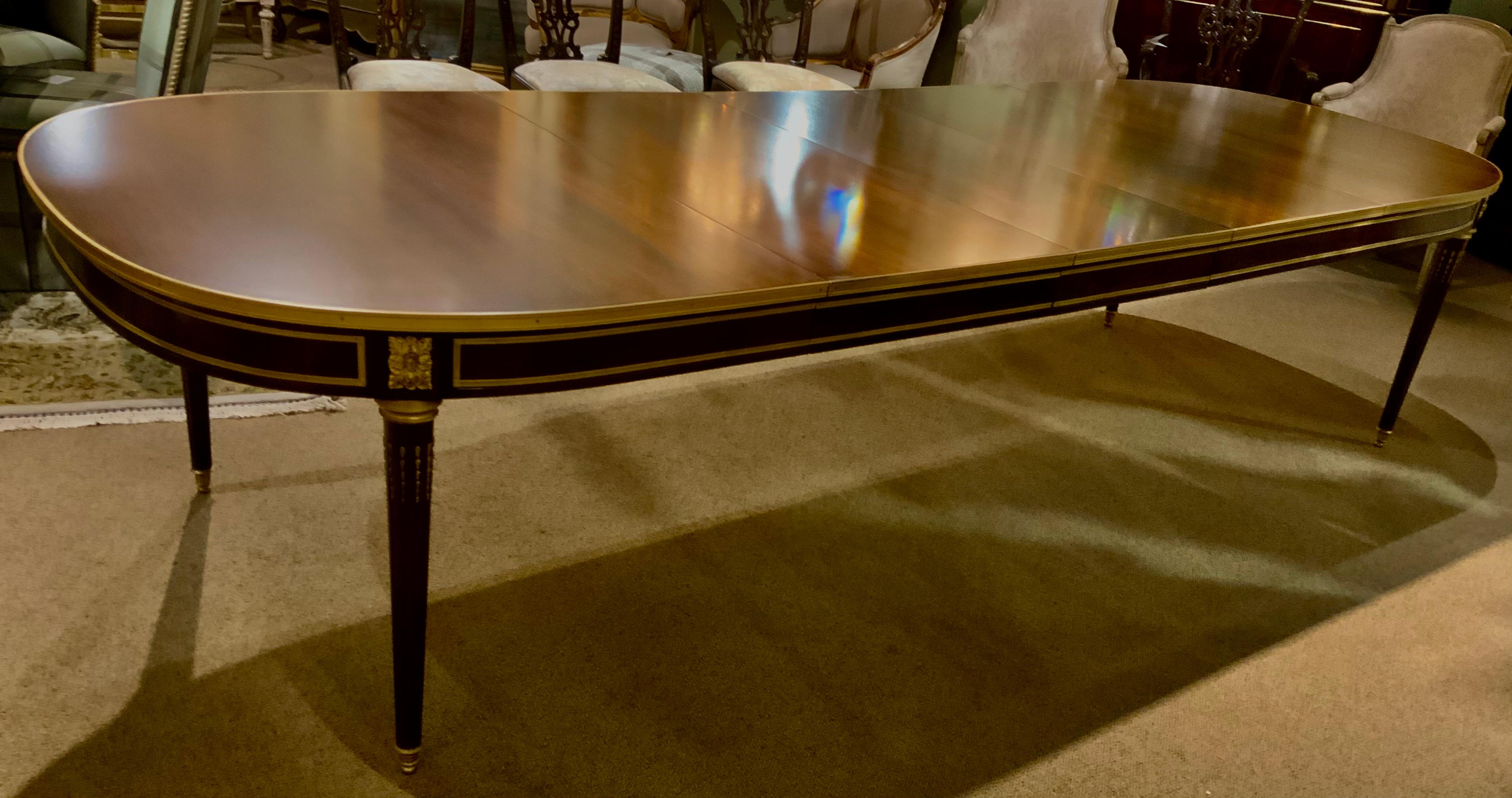The mahogany wood in this table is exceptional with lovely 
Graining and a fine satin finish. A gilt metal band surrounds
The edge of the table top. The legs are reeded and have
Gilt metal embellishments. The apron on the table is 4” deep.
The