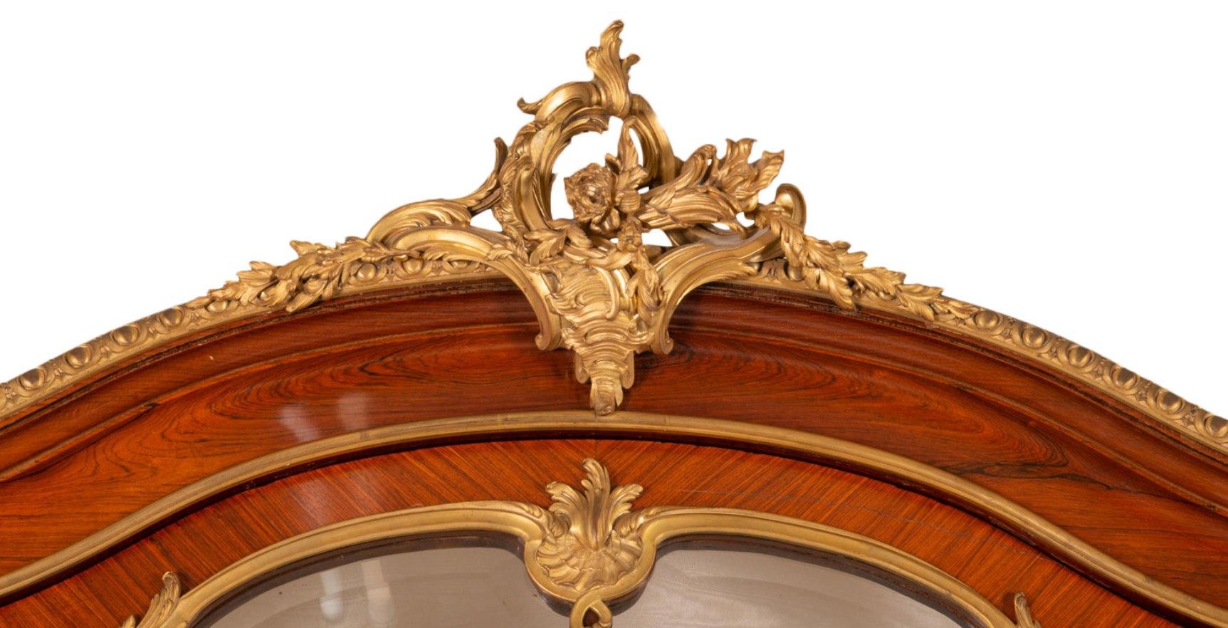 A very large and impressive fine quality 19th century French mahogany Virine, in the style of Louis XVI by 'Francoise Linke'.
Having wonderful gilded ormolu mounts of scrolling foliage, egg and dart moldings and classical females with head dresses.