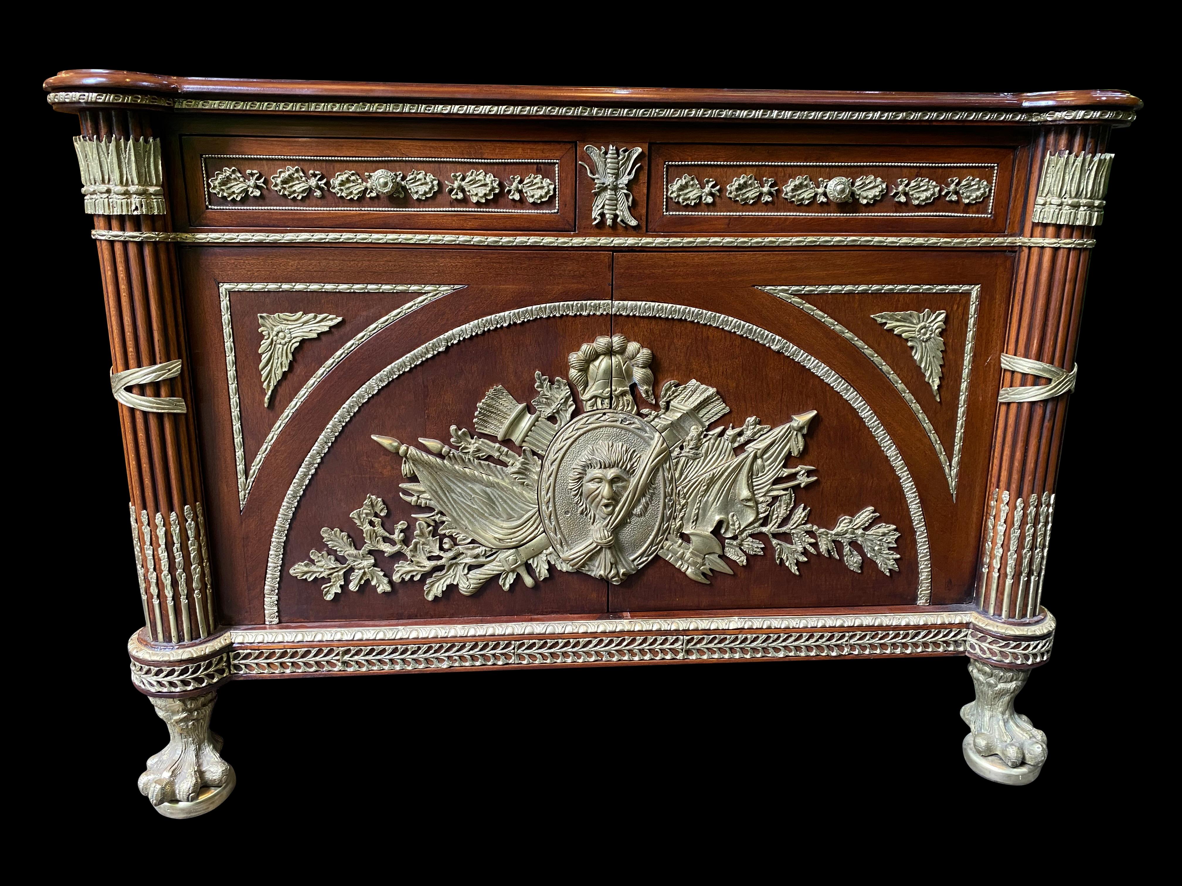 Large French mahogany Empire commode, with central coats of arms and lion paw feet, 20th century. Beautiful ormolu decoration with tall fluted carved columns. Perfect home decoration.