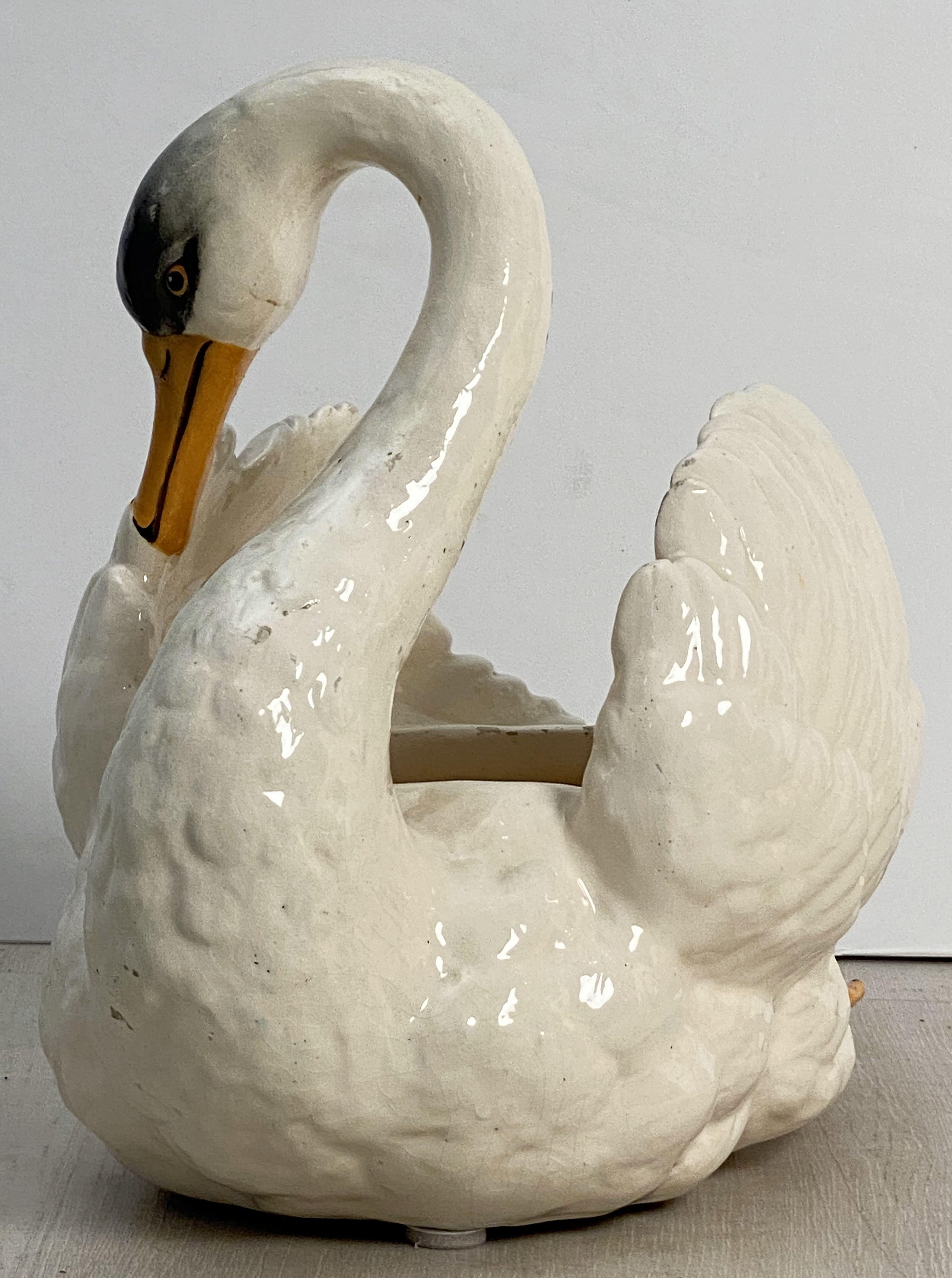 A fine French Majolica large swan planter by the celebrated Vallauris pottery firm, Massier, featuring an elegantly modeled swan in white with hand painted accents.