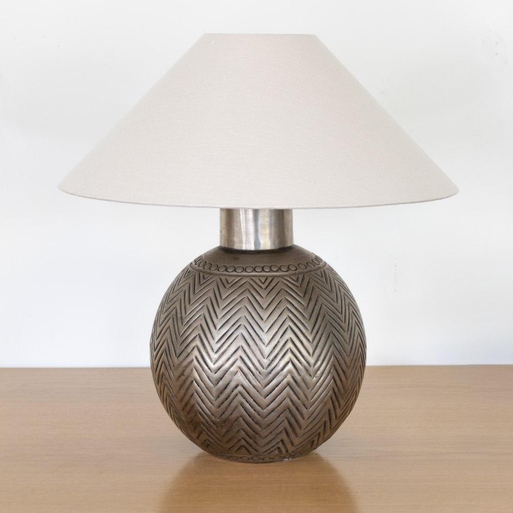 Stunning vintage metal table lamp from France. Silver globe metal body with etched Art Deco design detail. Newly re-wired with new tapered linen shade. Unique and striking piece. Takes one E26 base bulb, 40 W or higher using LED.
