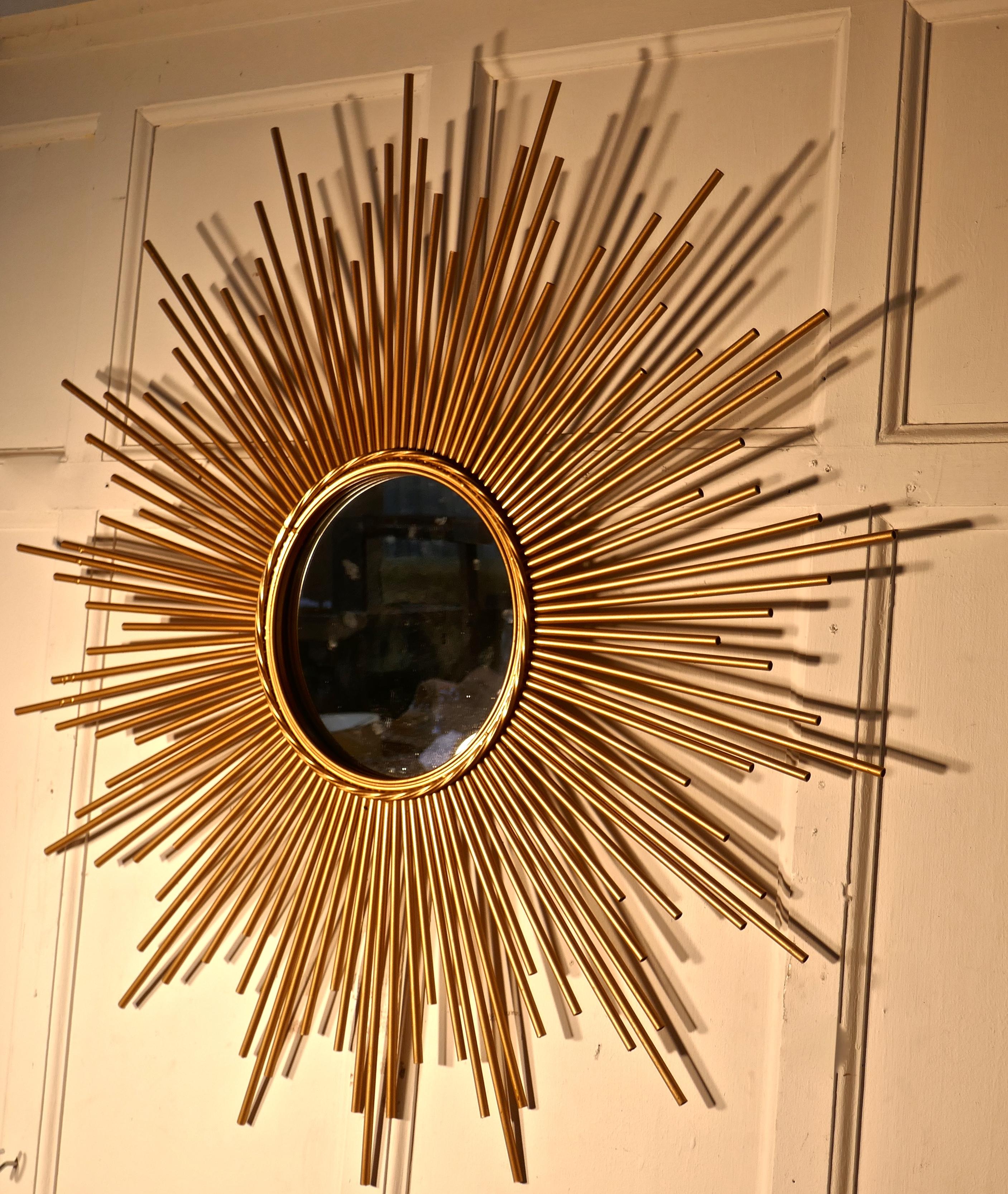 Large French midcentury sunburst-starburst brass mirror.

A Great piece, the large starburst or sunburst radiates out from the central convex mirror, the rays are in gold painted tubular brass
A Classic from the era, a very large statement