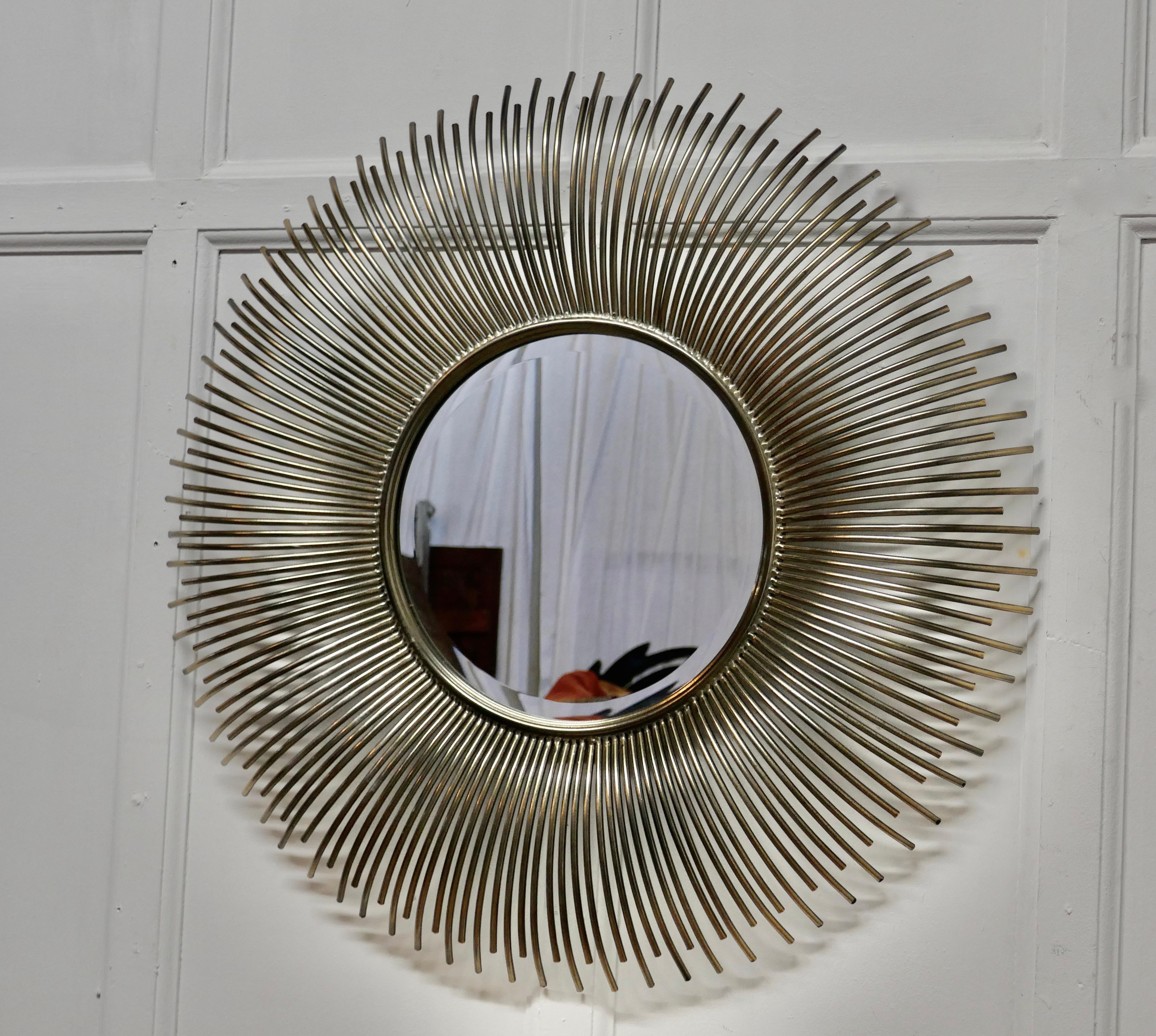 Large French midcentury sunburst-starburst steel mirror

A great piece, the large starburst or sunburst radiates out from the central beveled mirror, the rays are made in delightfully curved tubular steel
A Classic from the era, a very large