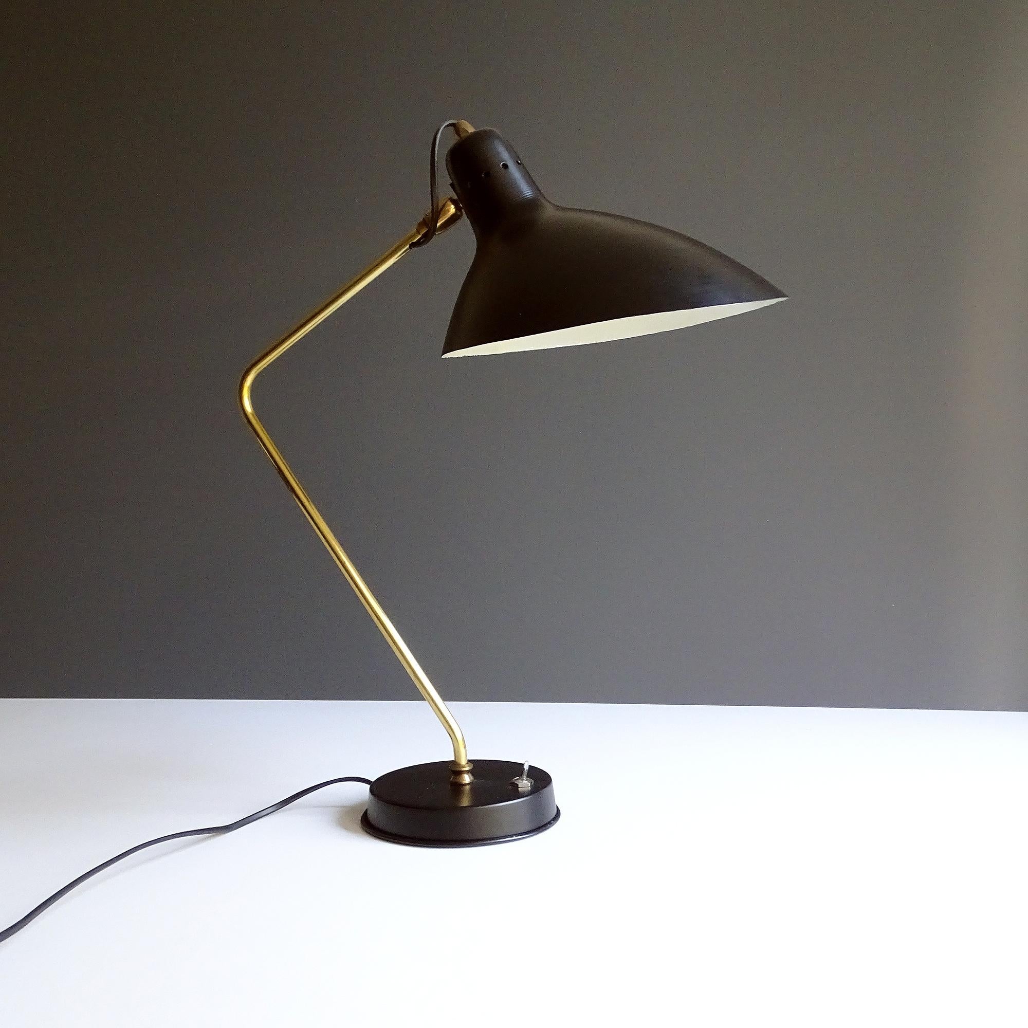 Mid Century Desk lamp by Jean Boris Lacroix, circa 1955-1960 with its signature elongated shade and bend brass stem, extremely rare early version with aircraft type switch.  Wiring: The lamps have been tested with US American light bulbs under 120v