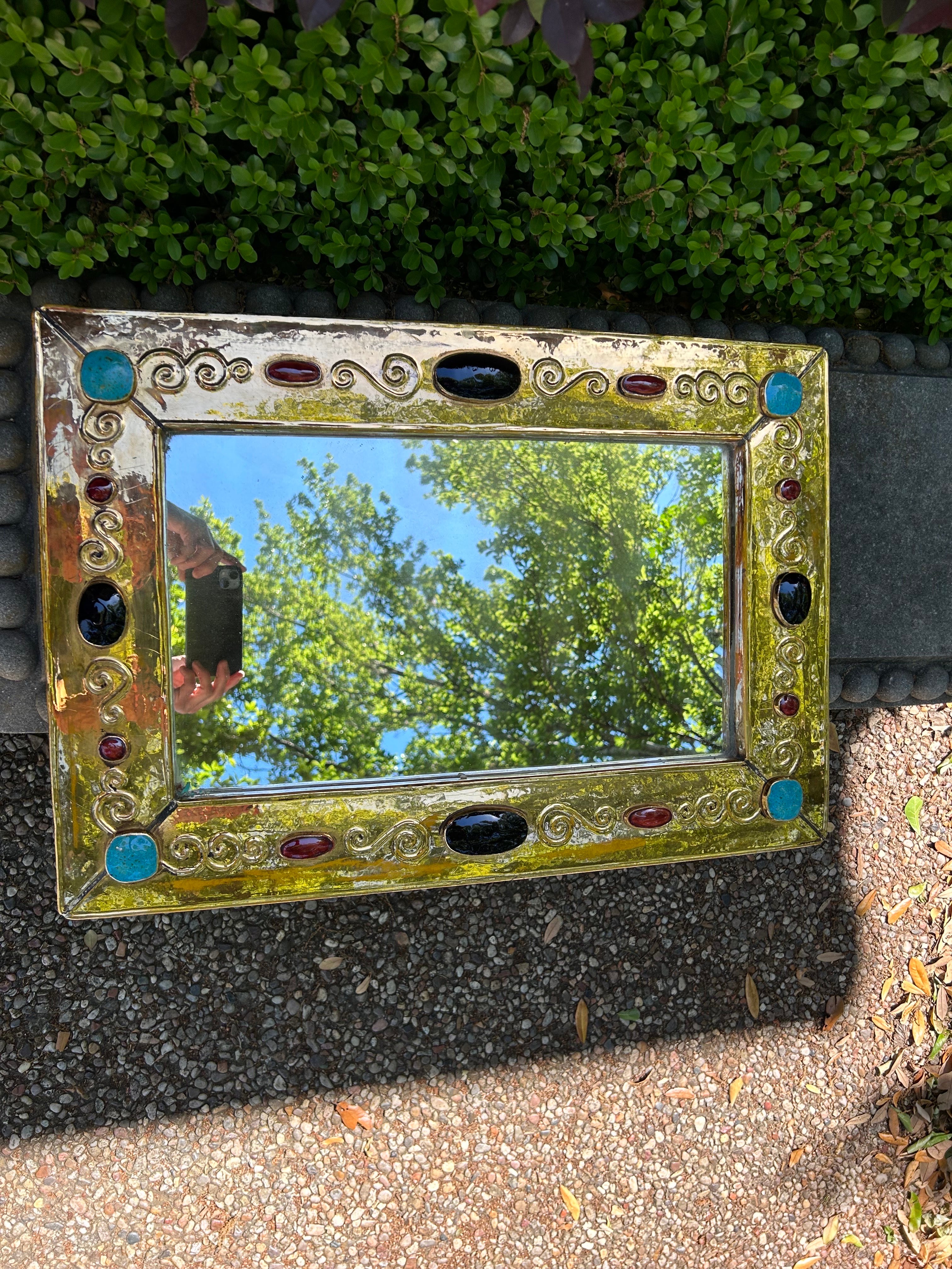 Large French Modern Ceramic Mirror Signed F. Lembo.
Francois Lembo mirror in gilt fired ceramic decorated with turquoise, red-orange and black inset jewels. This French mid century ceramic mirror is incised with F. Lembo signature on the back.
This