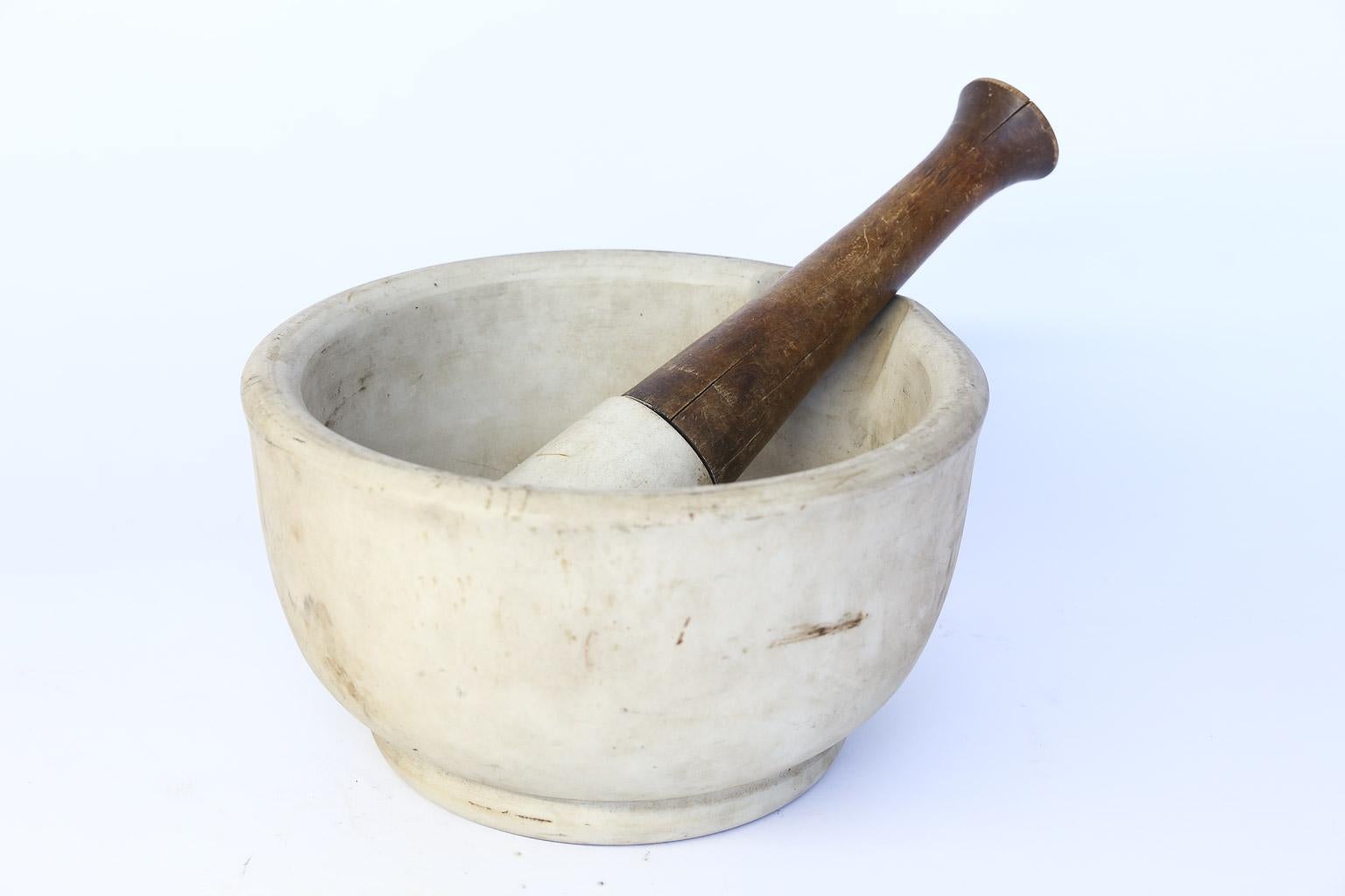 This is a generous size marble composition mortar and pestle from France. The pestle has a wood handle and measures 14.25 inches long and 3.25 inches in diameter. Dimensions for the mortar are given below. This is a perfect piece for any kitchen.