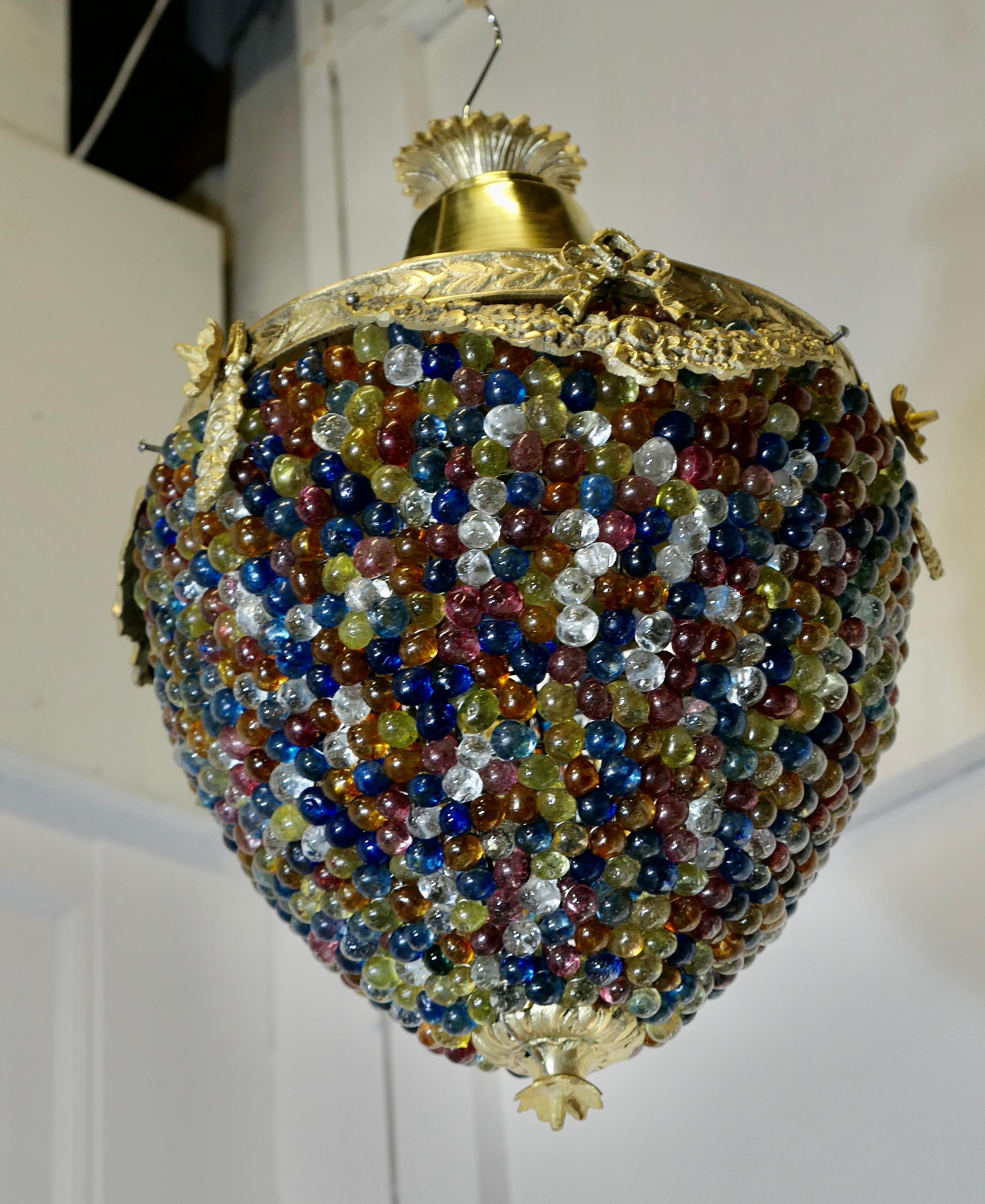 Large French Multi Coloured Teardrop Lamp Shade 

The Brass frame is very attractively set with coloured crystal beads and it is  decorated with Ormolu swags around the top  of the shade
A Fine Piece, in Brass set with many coloured crystal beads, a