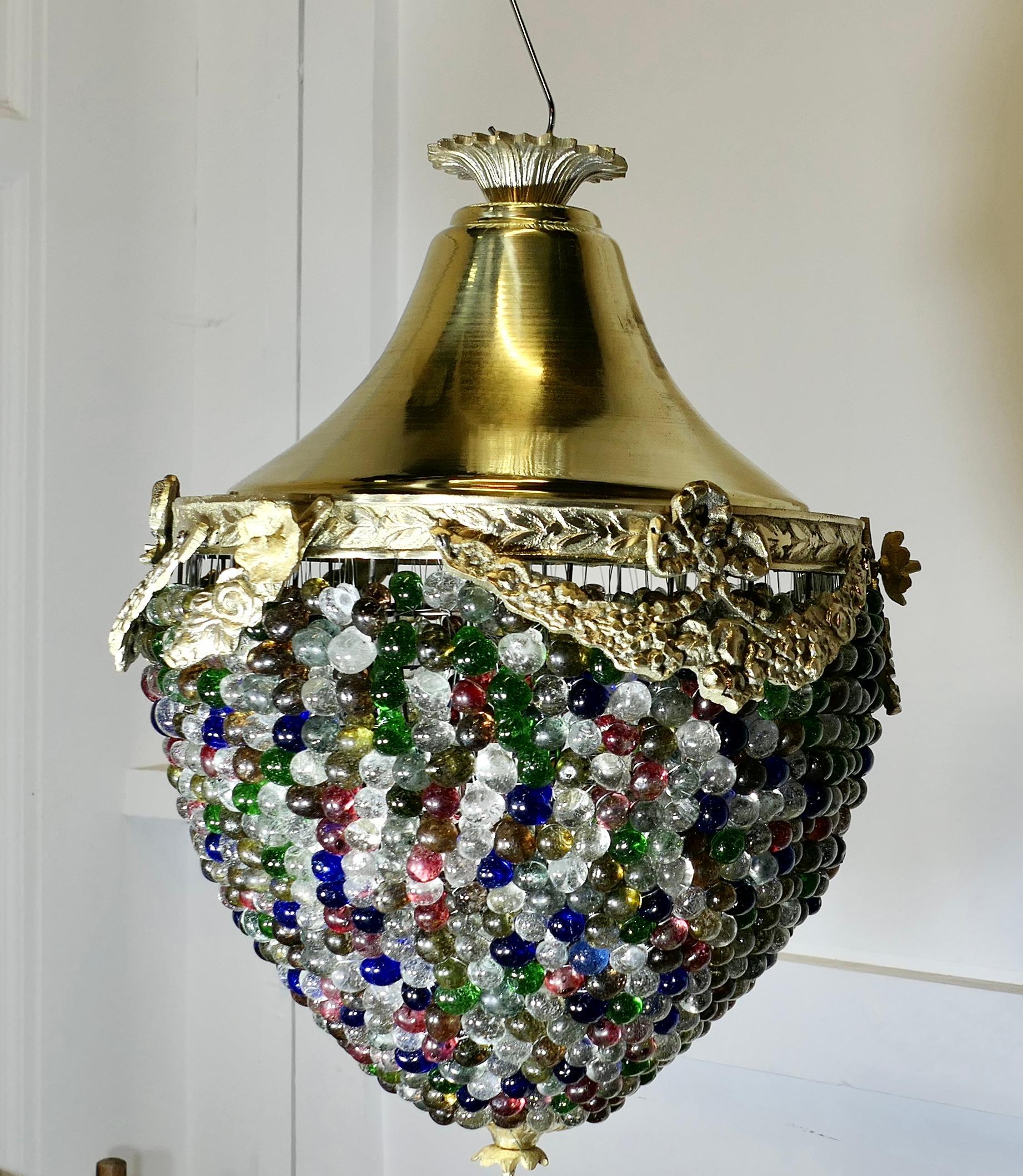 Large French Multi Coloured Teardrop Lamp Shade 

The Brass frame is very attractively set with coloured crystal beads and it is  decorated with Ormolu swags around the top  of the shade
A Fine Piece, in Brass set with many coloured crystal beads, a