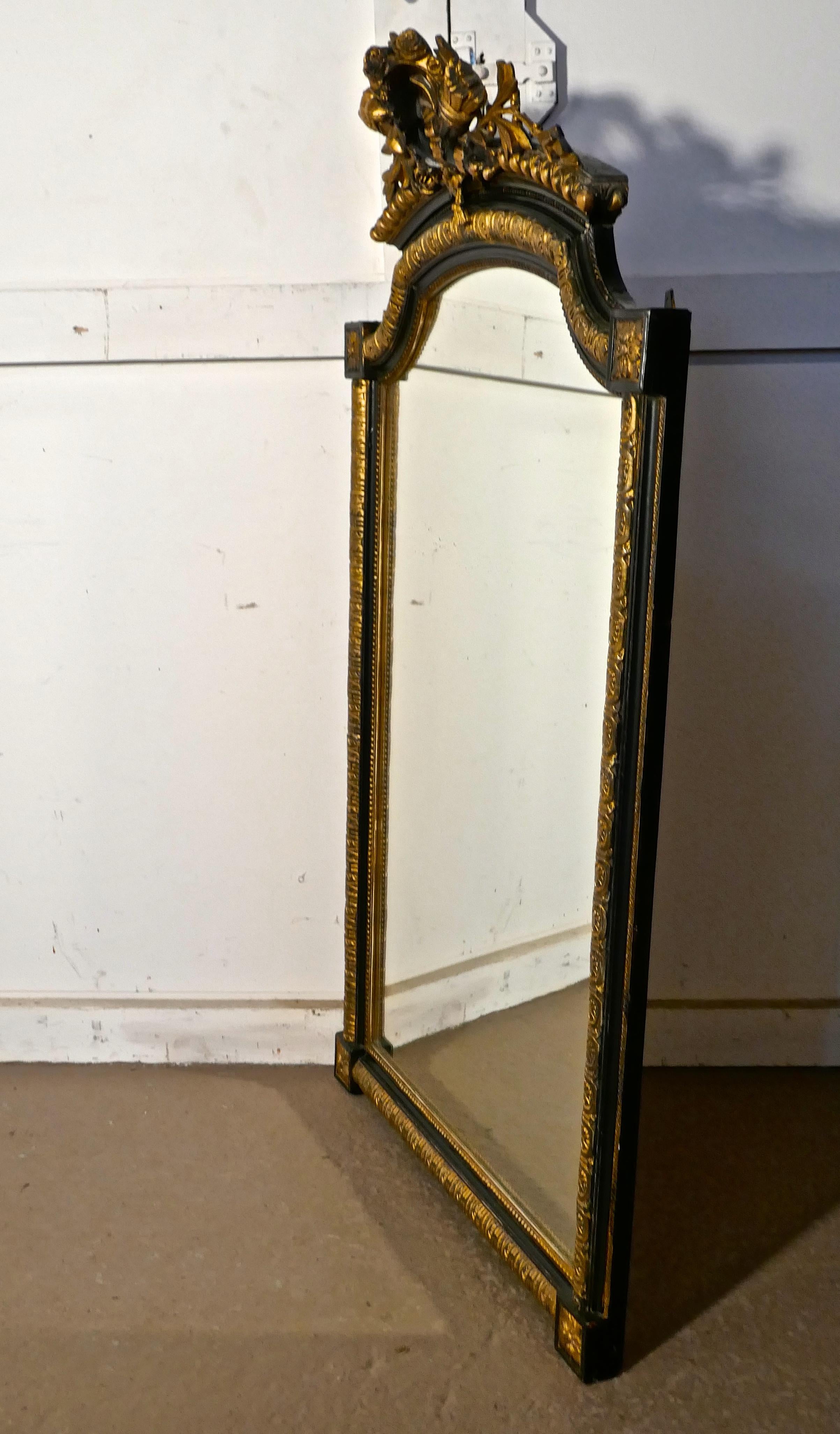 Large French Napoleon III ebonized and gilt wall mirror, torch and quiver crest

This is a very attractive piece, the mirror is ebonised with gilt decoration, in the centre at the top of the mirror there is an elaborate crest with a Laurel Leaf