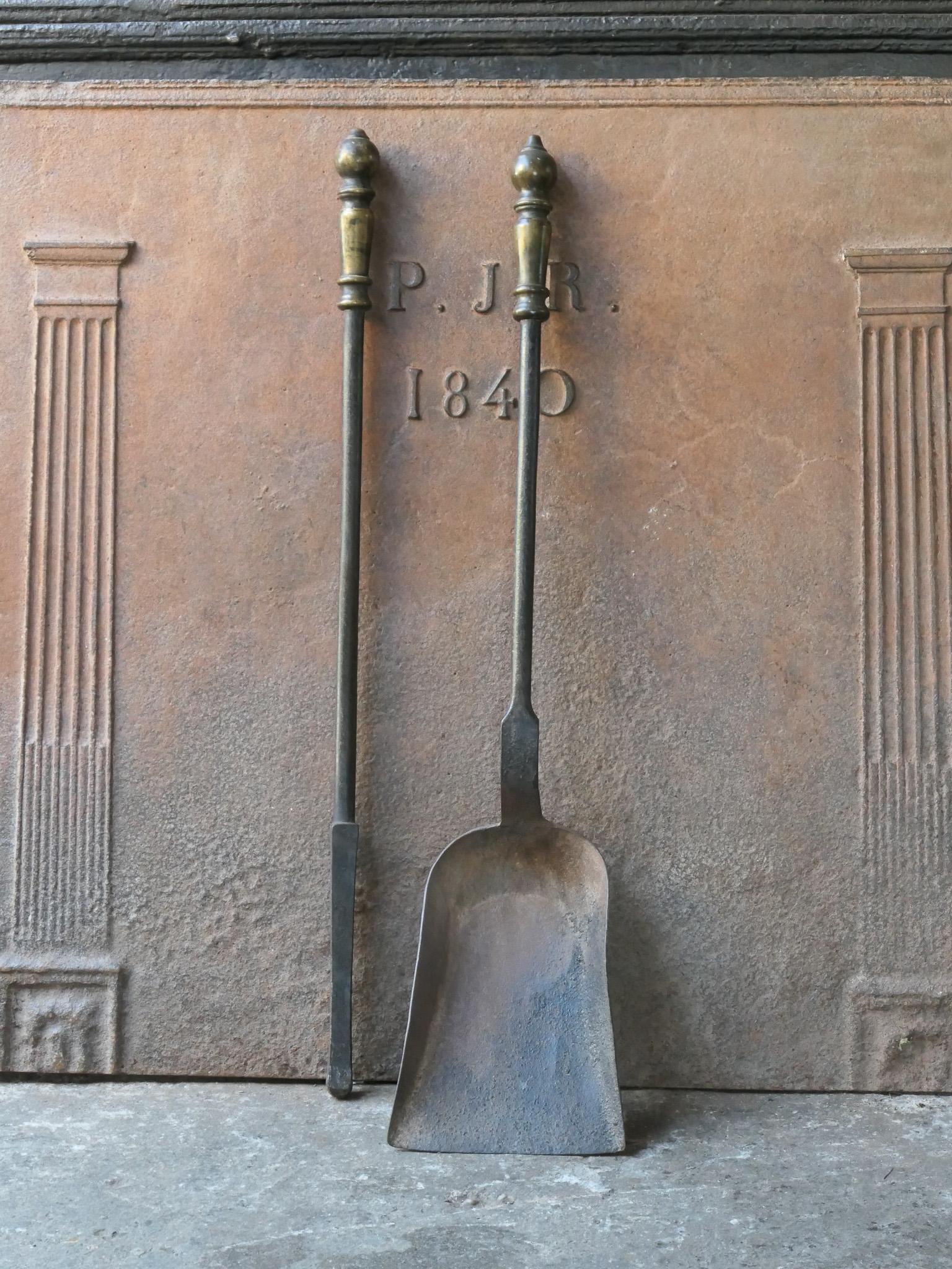 Large 19th-20th century French fireplace tool set. The tool set consists of a shovel, and fire poker. The tools are made of wrought iron and brass. The set is in a good condition and fit for use in the fireplace.