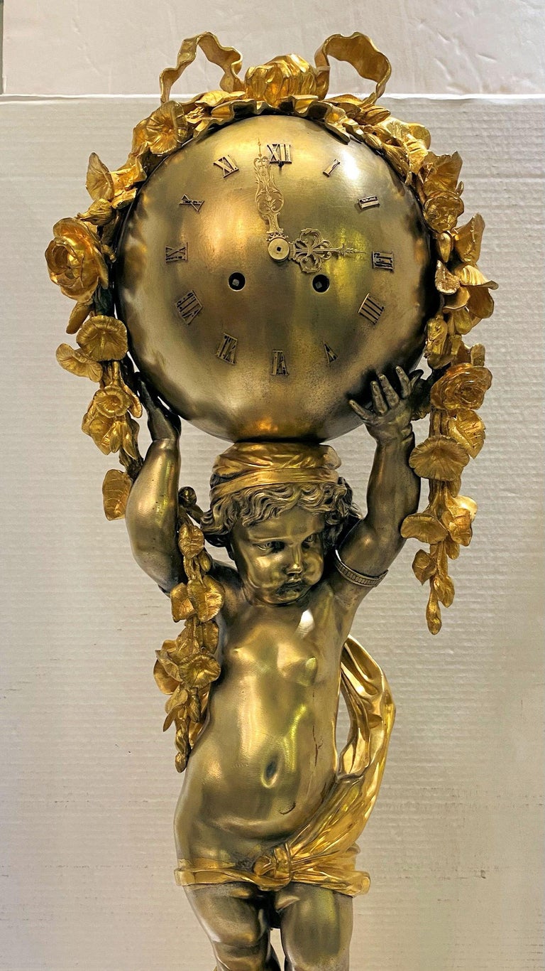Finest quality large French 19 century Louis XVI style gilt and silvered bronze clock depicting standing cupid.