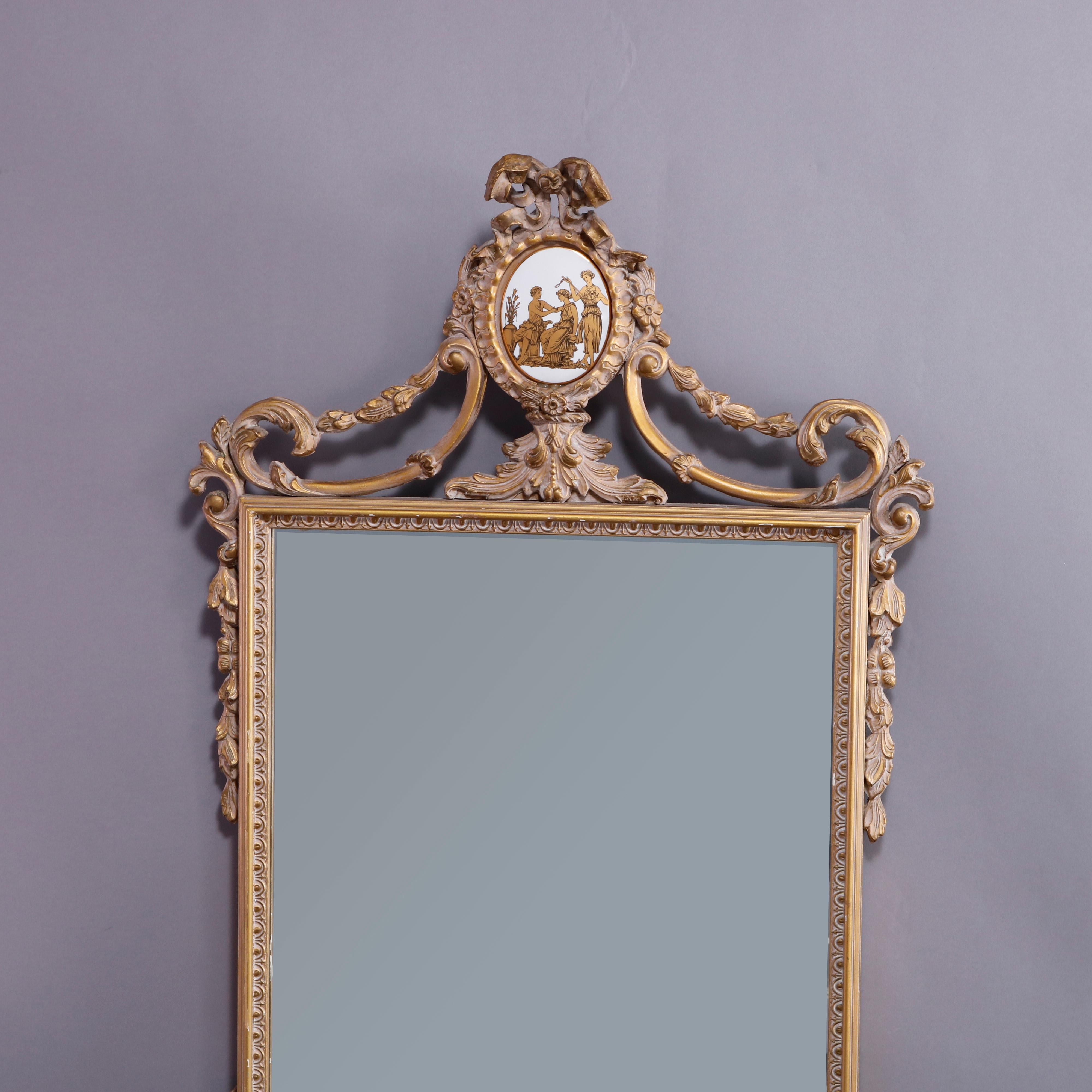 An antique and large French Neoclassical wall mirror offers gilt composition frame with medallion crest having porcelain insert with Classical scene, ribbon and bow surround over mirror with foliate frame, 20th century

Measures: 48.5