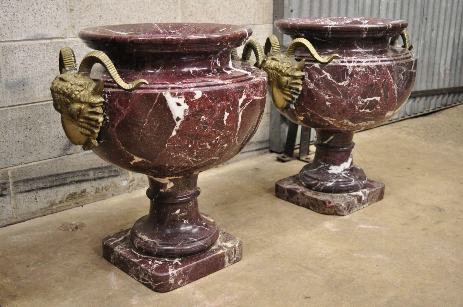 Large French Neoclassical Style Rouge Marble Bronze Rams Head Urn Planters - a Pair. Item features a large impressive size, bronze rams head handles, carved marble urn form, beautiful rouge marble, very nice vintage pair, great style and form,