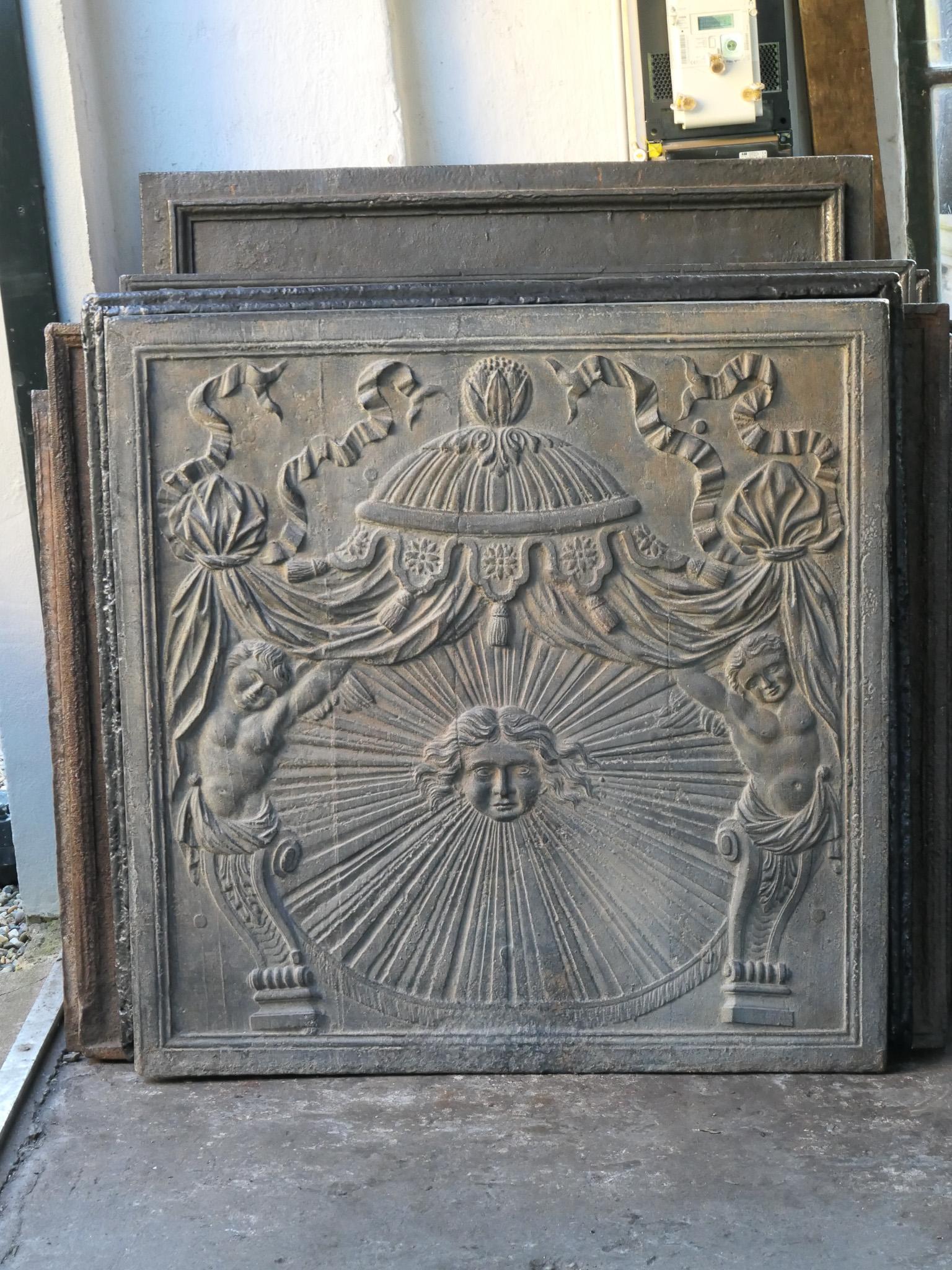Large 18th - 19th century French neoclassical period fireback with the sun. The sun is symbol voor king Louis XIV.

The fireback is in a good condition and does not have cracks.

This large fireback will be shipped as freight. Please contact us for