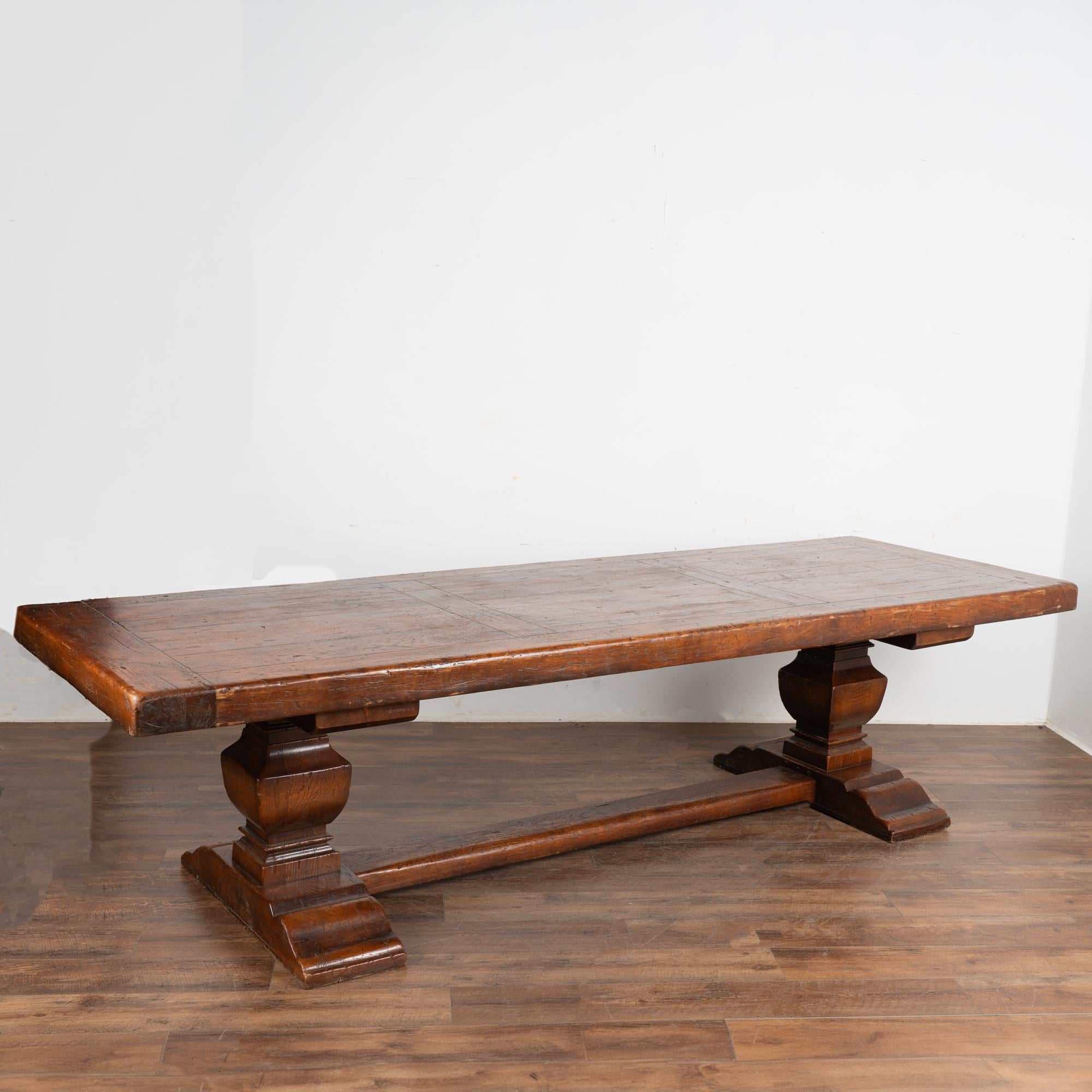 Impressive in size at just under 10' long, this dramatic dining table will make a grand gathering place in today's modern home.
The heavy oak top is impressive; rich character is revealed in the scratches, nicks, and distress which create the appeal