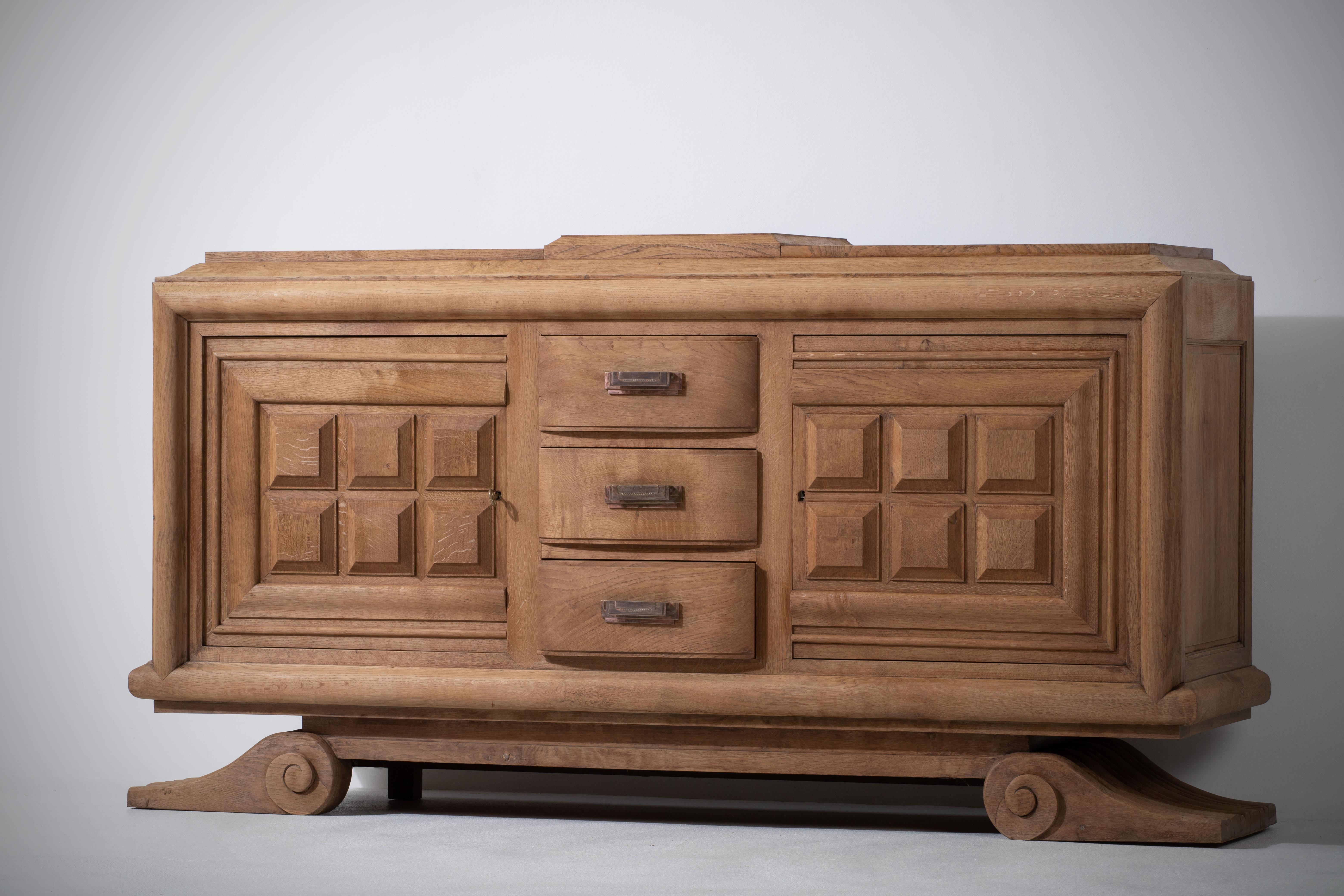 A large sideboard/credenza attributed to Charles Dudouyt. 
France, circa 1940s.
Consists of two storage compartments and a central drawers column. 
The sideboard is in good original condition, with minor wear consistent with age and use.
A truly