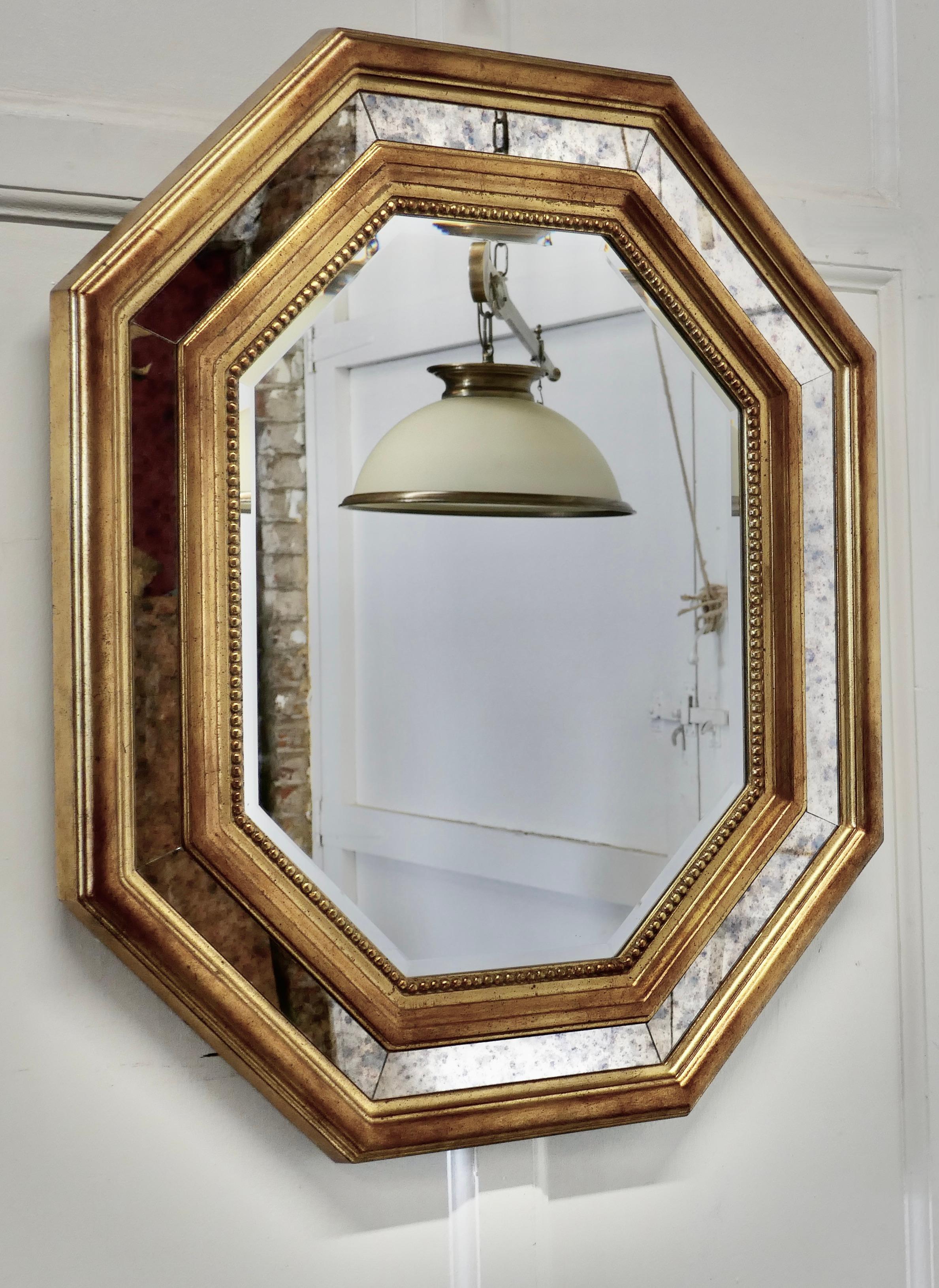 Large French octagonal cushion mirror

This is a lovely and a fine quality cushion Mirror, the frame takes a double form with the mirror between slightly mottled, giving an aged effect
The central Mirror is bevelled, there is very little wear to
