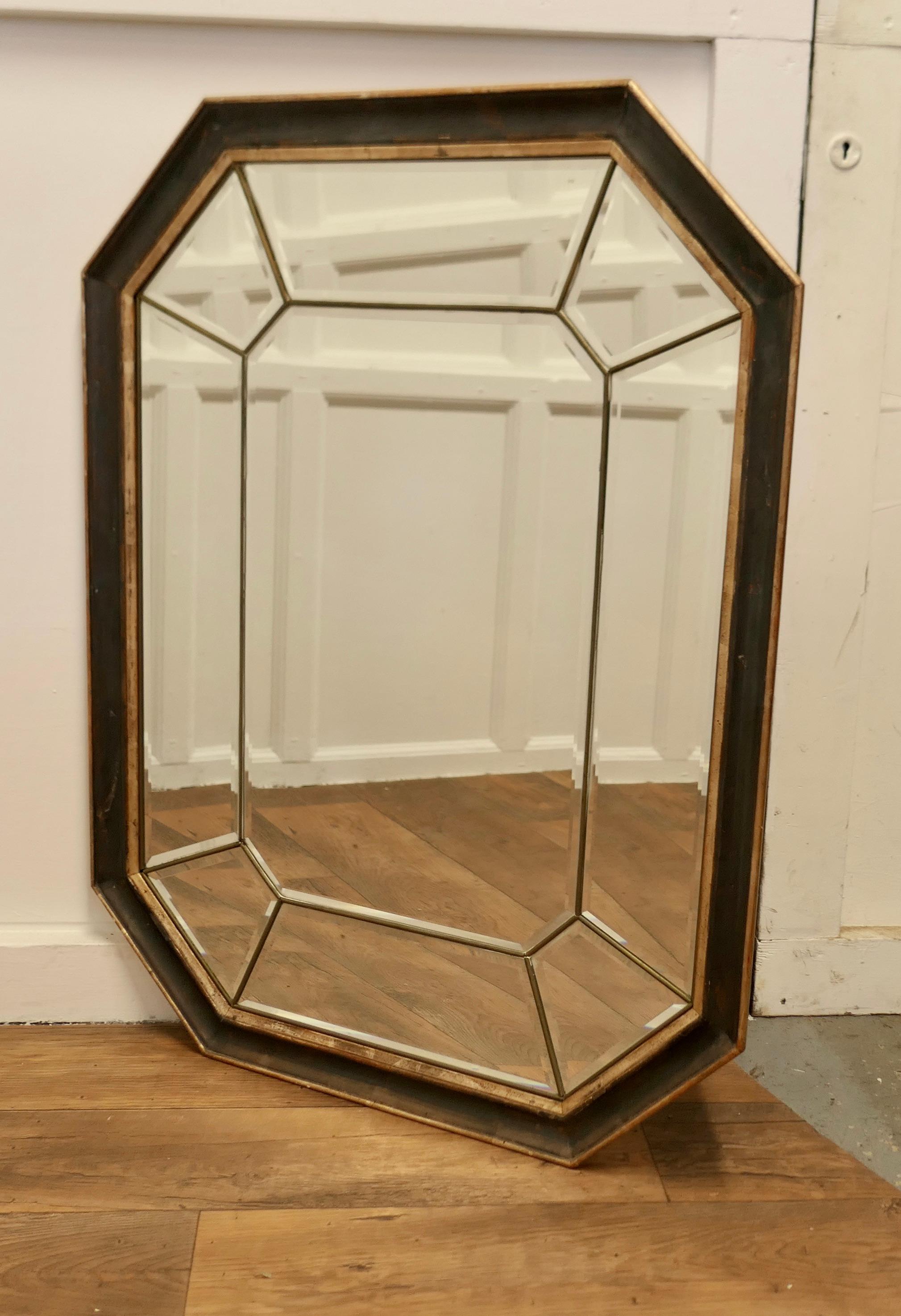Large French Octagonal Cushion Mirror

This is a lovely and a fine quality cushion Mirror, the 9” frame takes a double form with the central mirror between brass edged mirrors which form a second frame
All the mirrors are bevelled, there is very