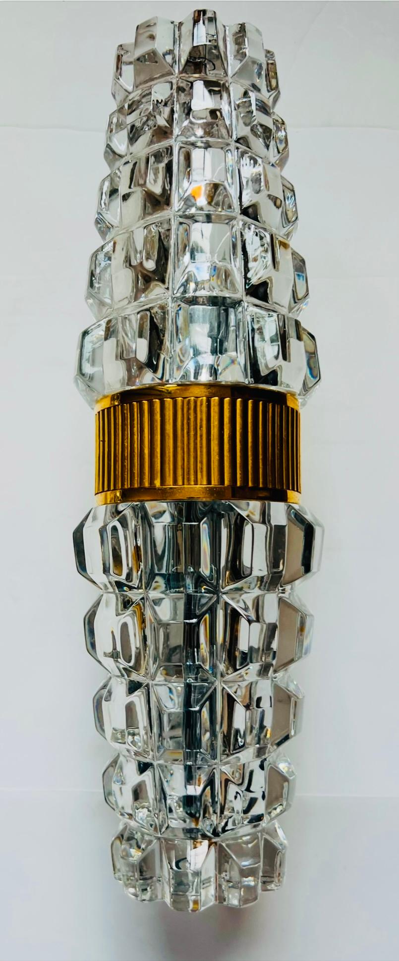 A luxurious heavy pair of French crystal wall lamps with a gold plated fixtures made in the 1980s by Othr. Rewired. Rare. Two light candelabra light sockets.