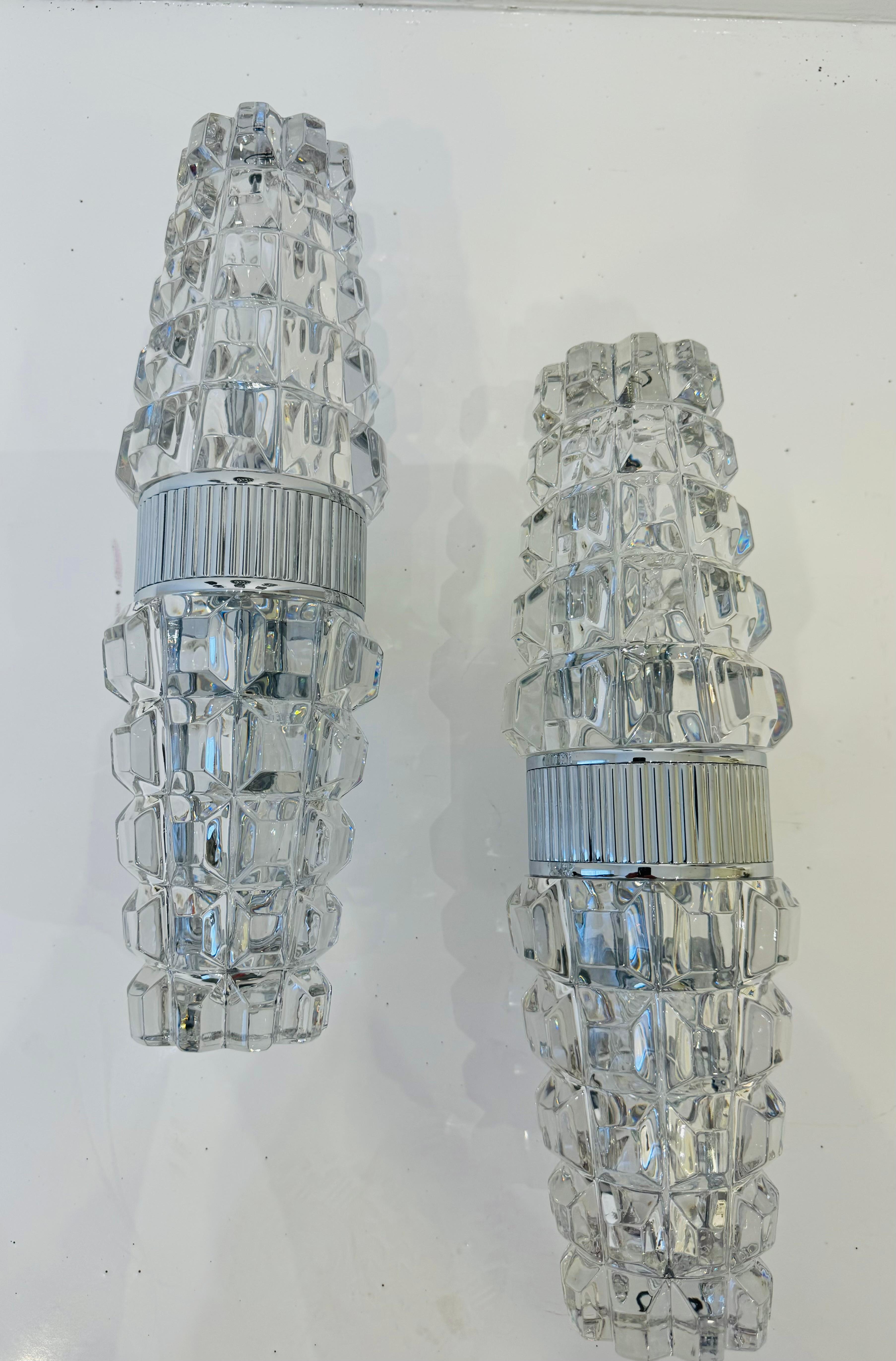 A luxurious heavy pair of French crystal wall lamps with a gold plated fixtures made in the 1980s by Othr. Rewired. Rare. Two light candelabra light sockets.