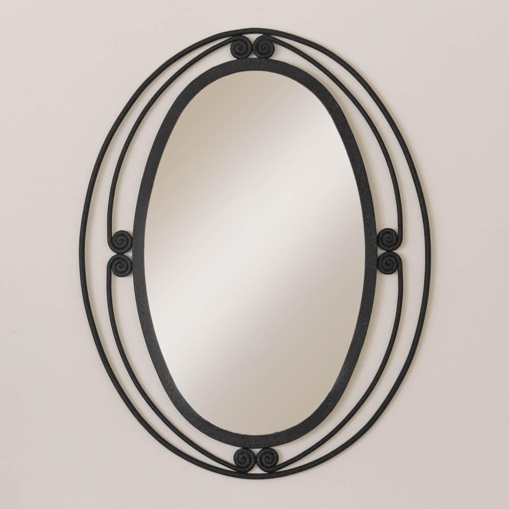 Beautiful iron mirror from France, 1950's. Large vintage oval iron frame with lovely spiral iron detail. Original iron finish and mirror show nice age and patina. Perfect for a powder room, bedroom vanity, or entryway. 