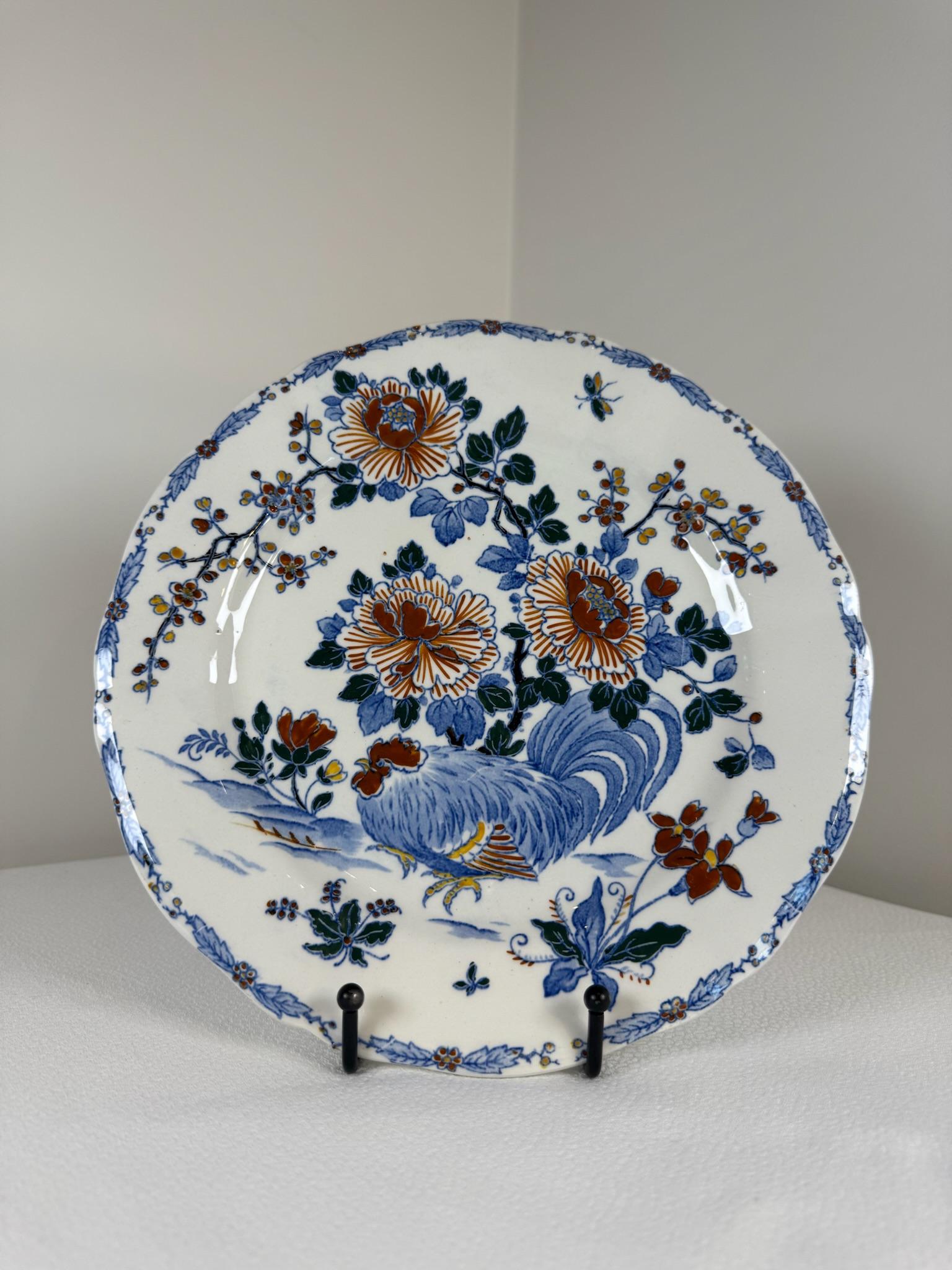 This exquisite porcelain set from the renowned French manufacture Faïencerie de Gien showcases the classic “Coq et Pivoine” (Rooster and Peony) motif. Celebrating timeless elegance and French country charm, each piece features vibrant, intricately