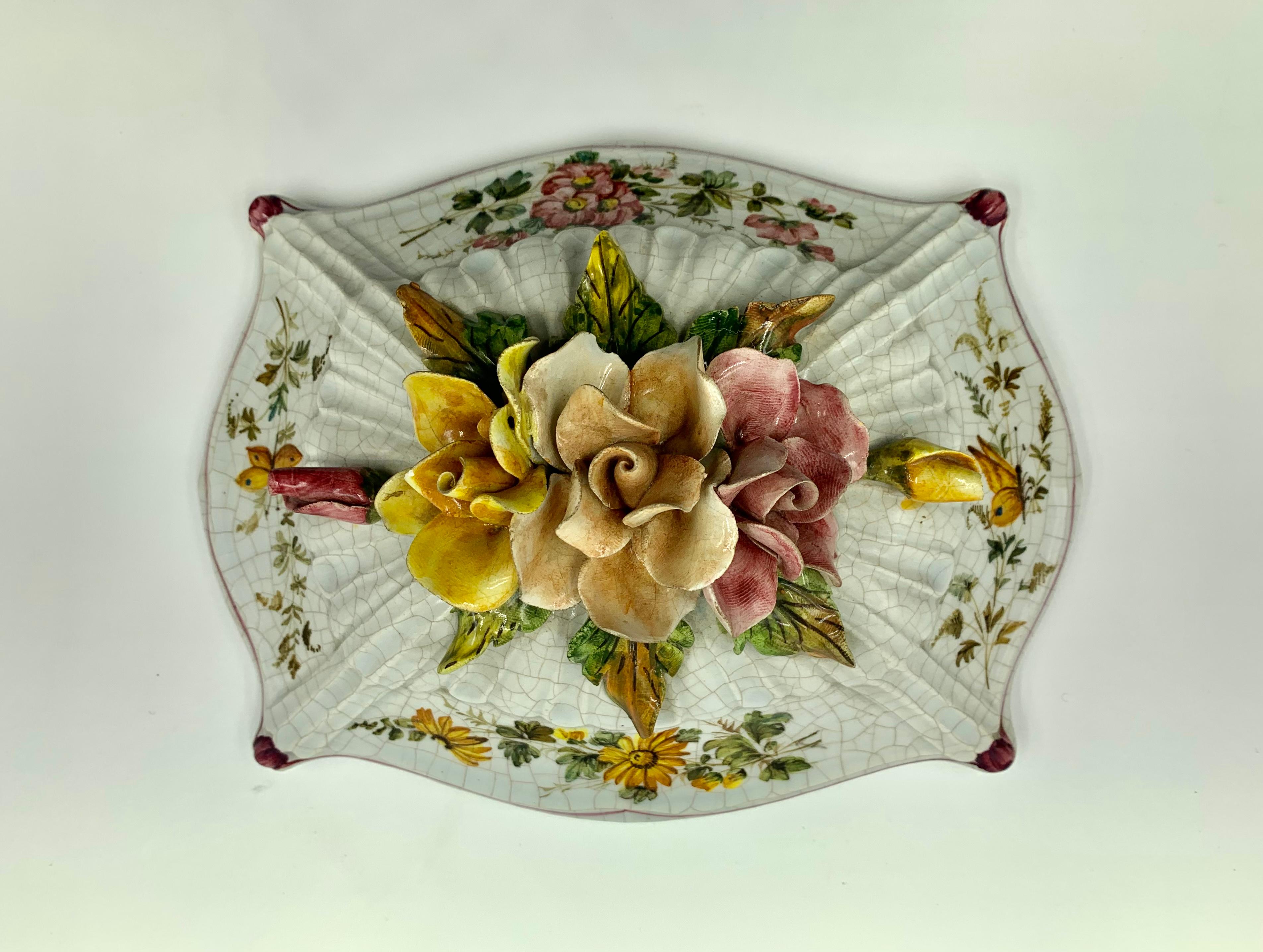Beautiful, large French Provincial style faience covered box profusely decorated with vibrant bouquets of flowers against a marvelous craquelure background. The cover topped with five roses, three in full bloom and two buds in apricot, yellow and