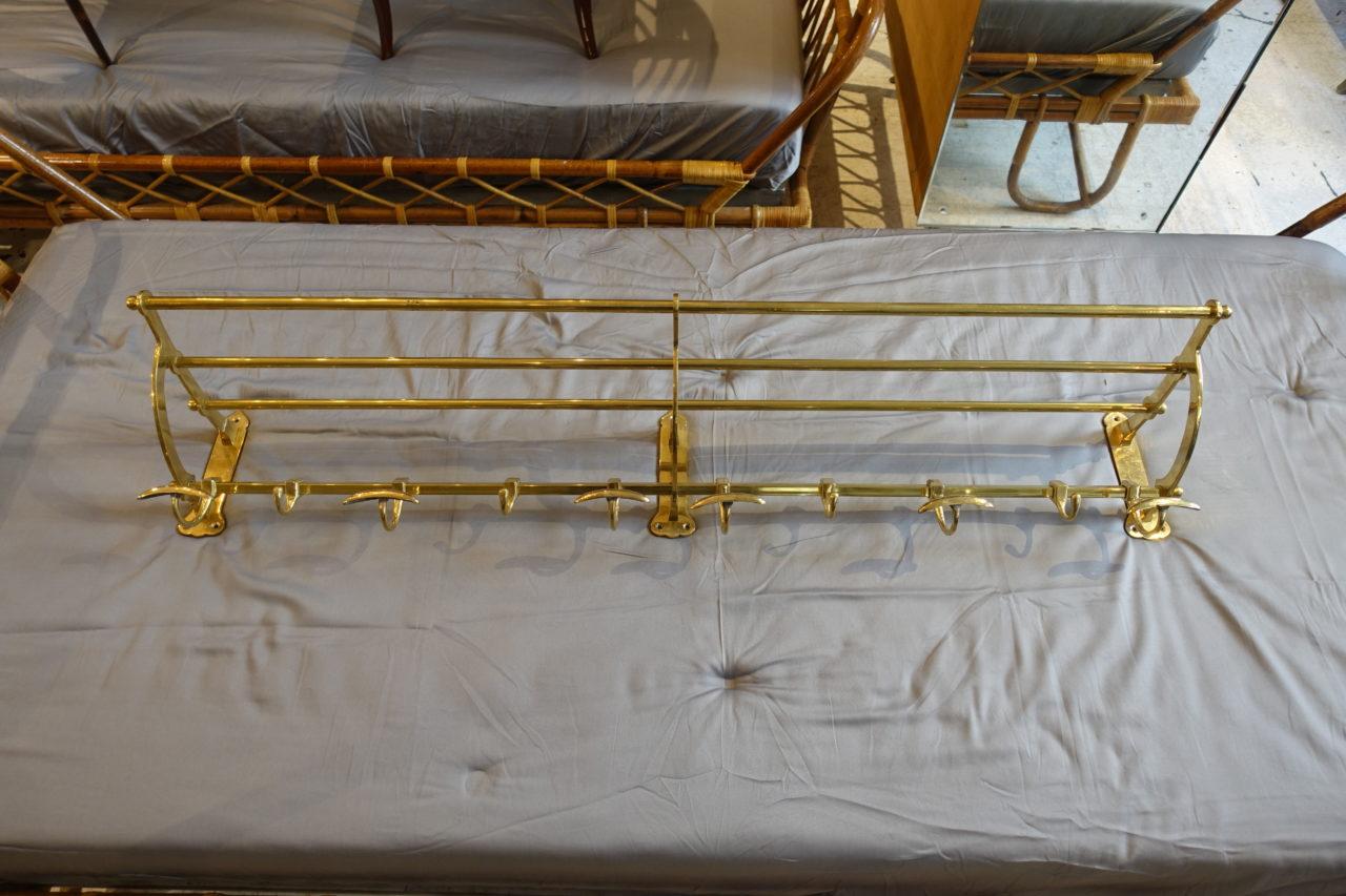 Handsome long vintage French hat shelf consisting of three quality brass rods, and coat rack with 10 hooks for outer wear. A beautiful and elegant way to maintain order in an entrance hall. Fabulous craftsmanship. Newly polished and a stunning sheen.