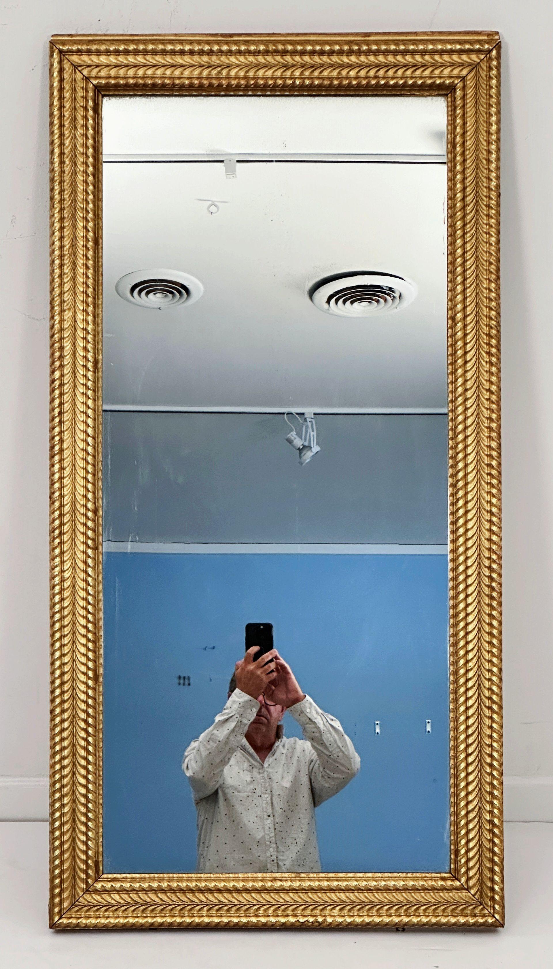 A handsome large French gilt rectangular wall mirror, with original glass, featuring a decorative raised, ripple edged moulding around the circumference of the frame and a lovely patina.

Ready to hang - Can be displayed vertically (portrait) or