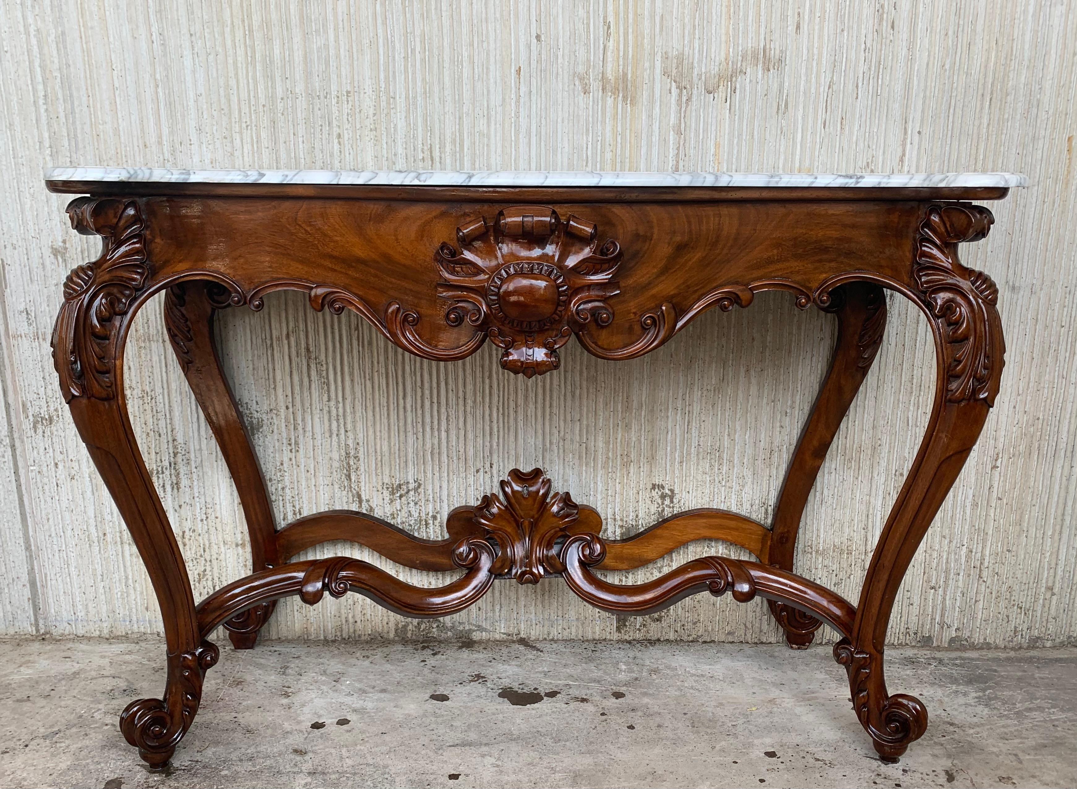 19th French Regency carved walnut console table with marble top

19th century French Regence style beautifully carved with leaves walnut console. White marble top with carved front, over hand-carved frieze supported by four cabriole legs connected