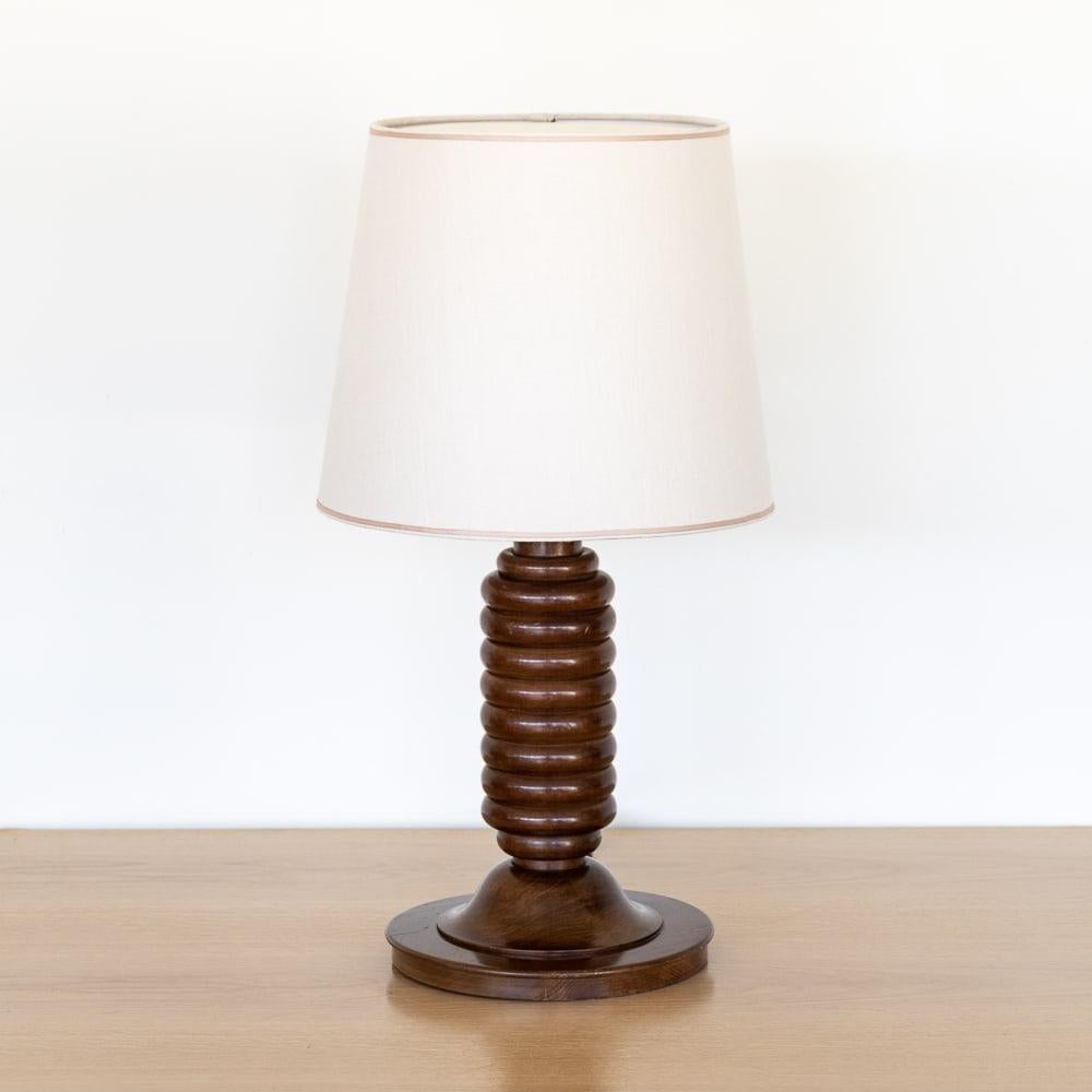 Beautiful vintage large wood table lamp from France, 1940s. Thick carved wood ribbed grooves in stem with original dark wood finish showing nice age and patina. New cream linen shade with tan trim and newly re-wired. Takes one E26 base bulb, 60 W or