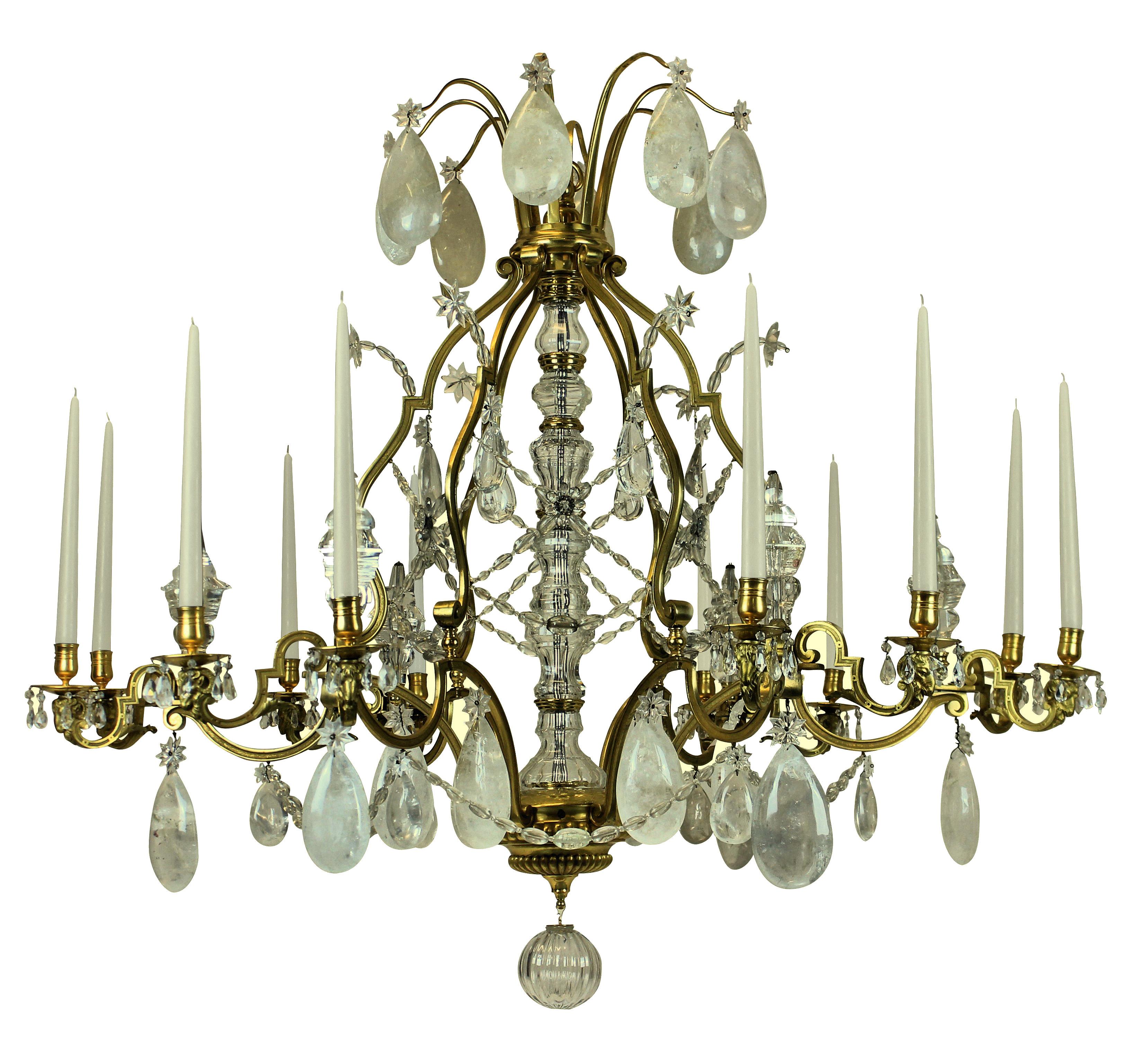 A large Louis XV style chandelier of the highest quality, with mercury gilded and burnished bronze and hung with rock crystal. With ram's head decoration to each arm, of which there are twelve in total, with beads, spires and pendant drops. Can be