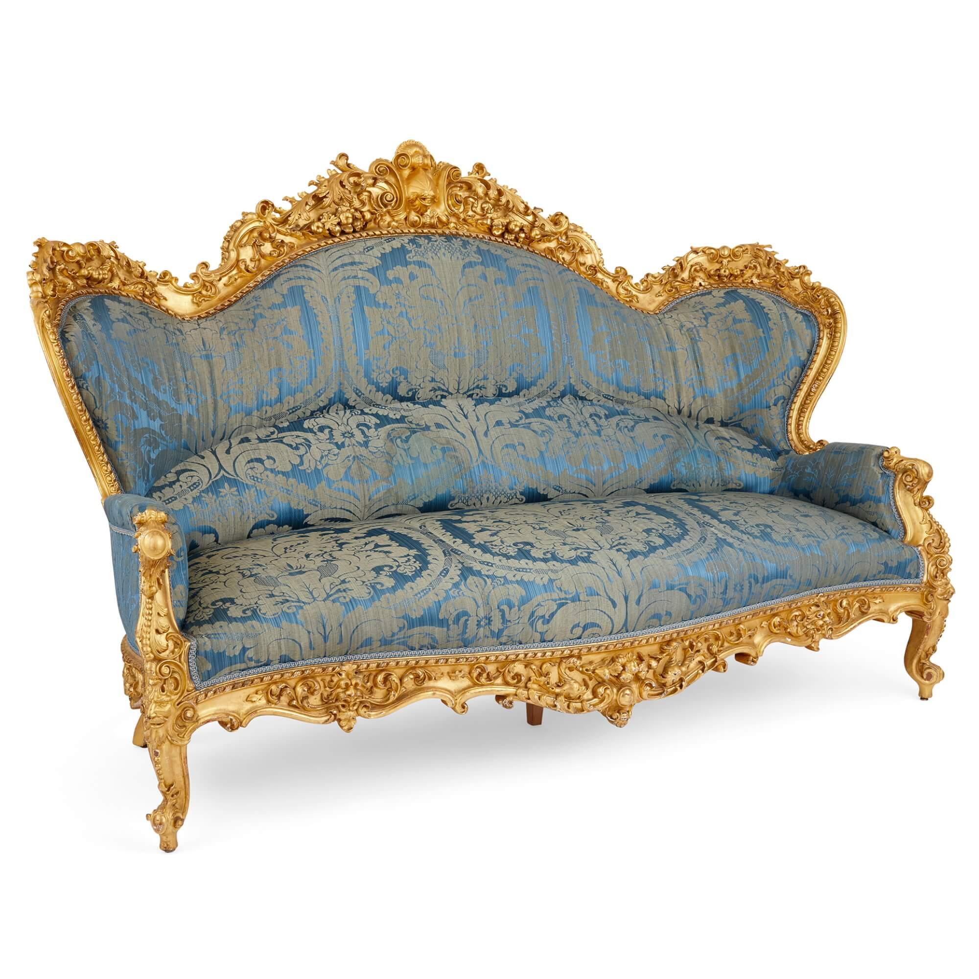 Large French Rococo Revival style giltwood sofa.
French, late 19th century.
Measures: height 135cm, width 196cm, depth 90cm.

This remarkable piece is a large, French, Rococo revival carved giltwood sofa made in the late nineteenth century,