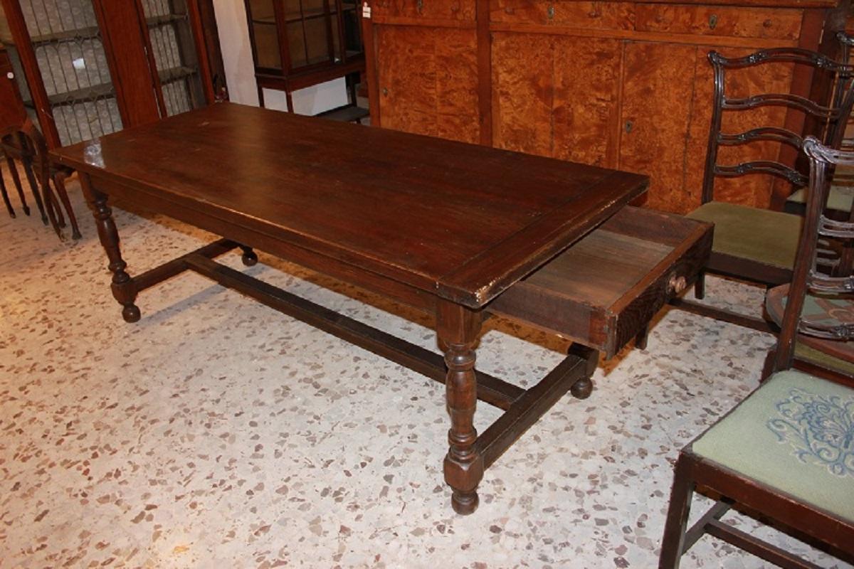 Large rectangular rustic table from the early 1800s in seventeenth-century style, made of chestnut wood. It features 1 large under-counter drawer and legs with turnings joined by a stretcher.

Origin: France

Period: Early 1800s

Style: 17th