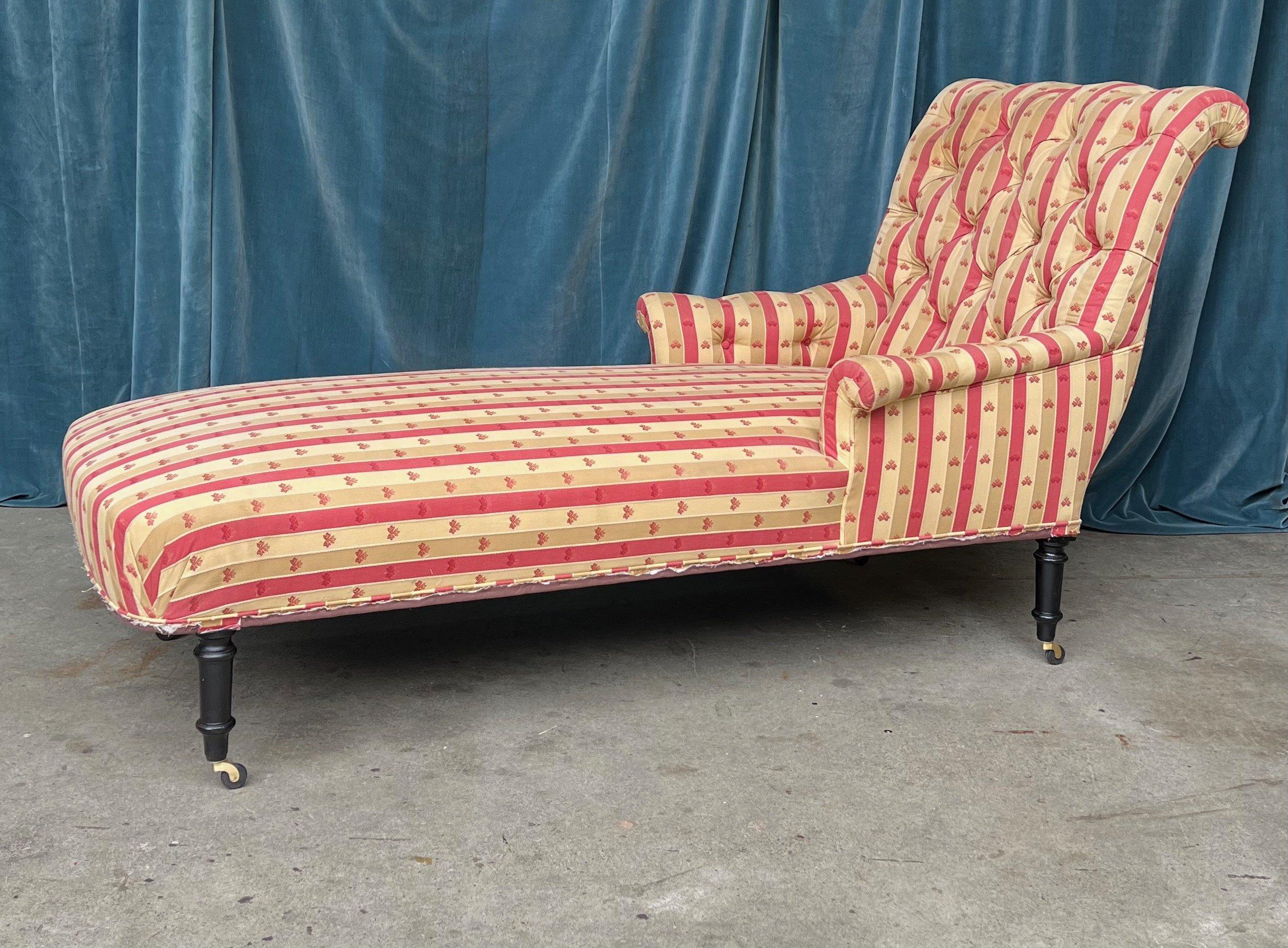 An exquisite French Napoleon III chaise lounge. Take comfort and relaxation to a whole new level with this attractive French late 19th century Napoleon III scrolled back chaise longue. Recently upholstered in a beautiful patterned striped fabric,
