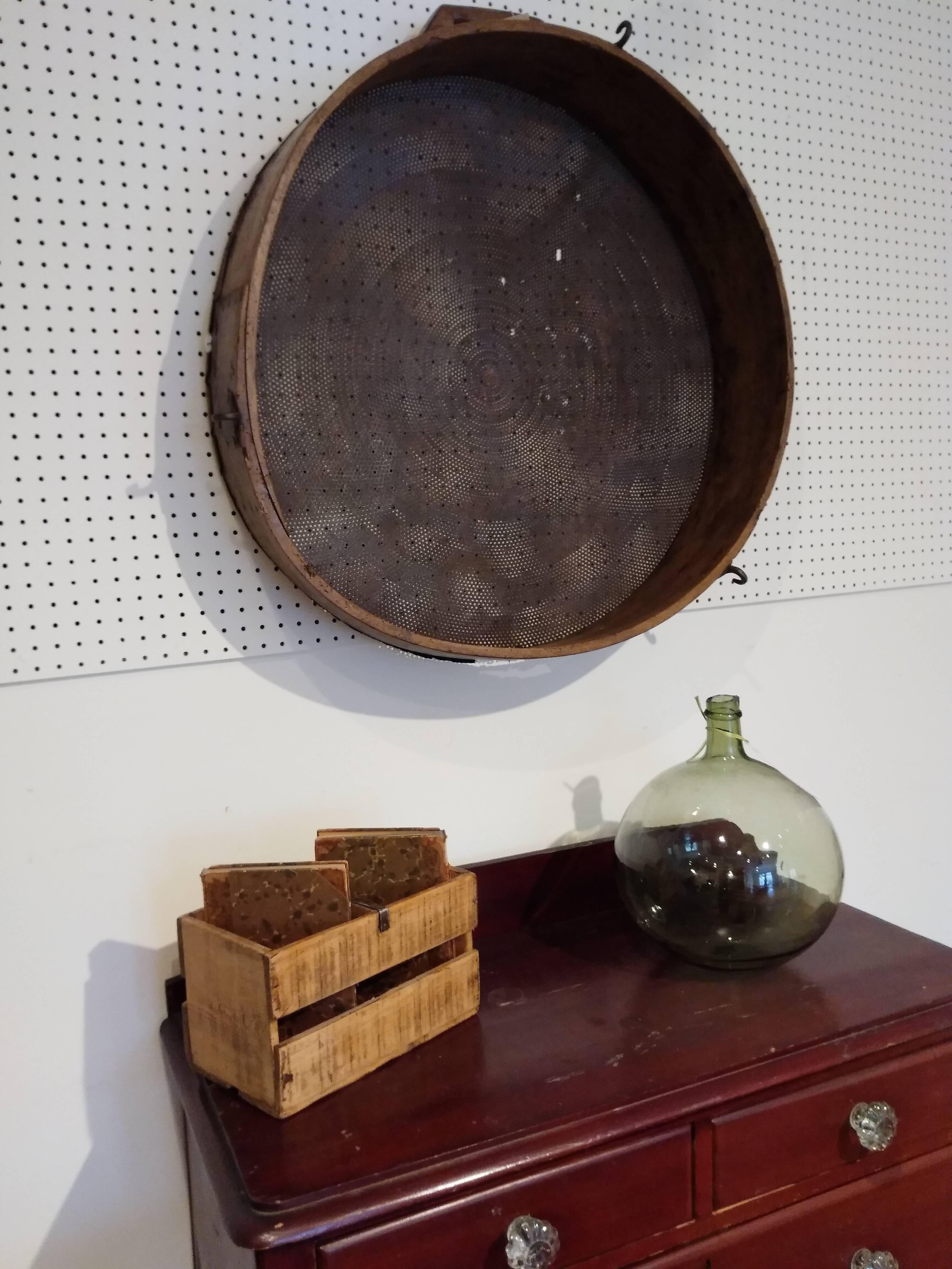 If you are looking for a large piece to hang on the walls of your country home your ship has arrived. The rim is wood and a bit warped with age and the middle is metal. It dates from 1870. There is a handle on top of the piece and we love this piece