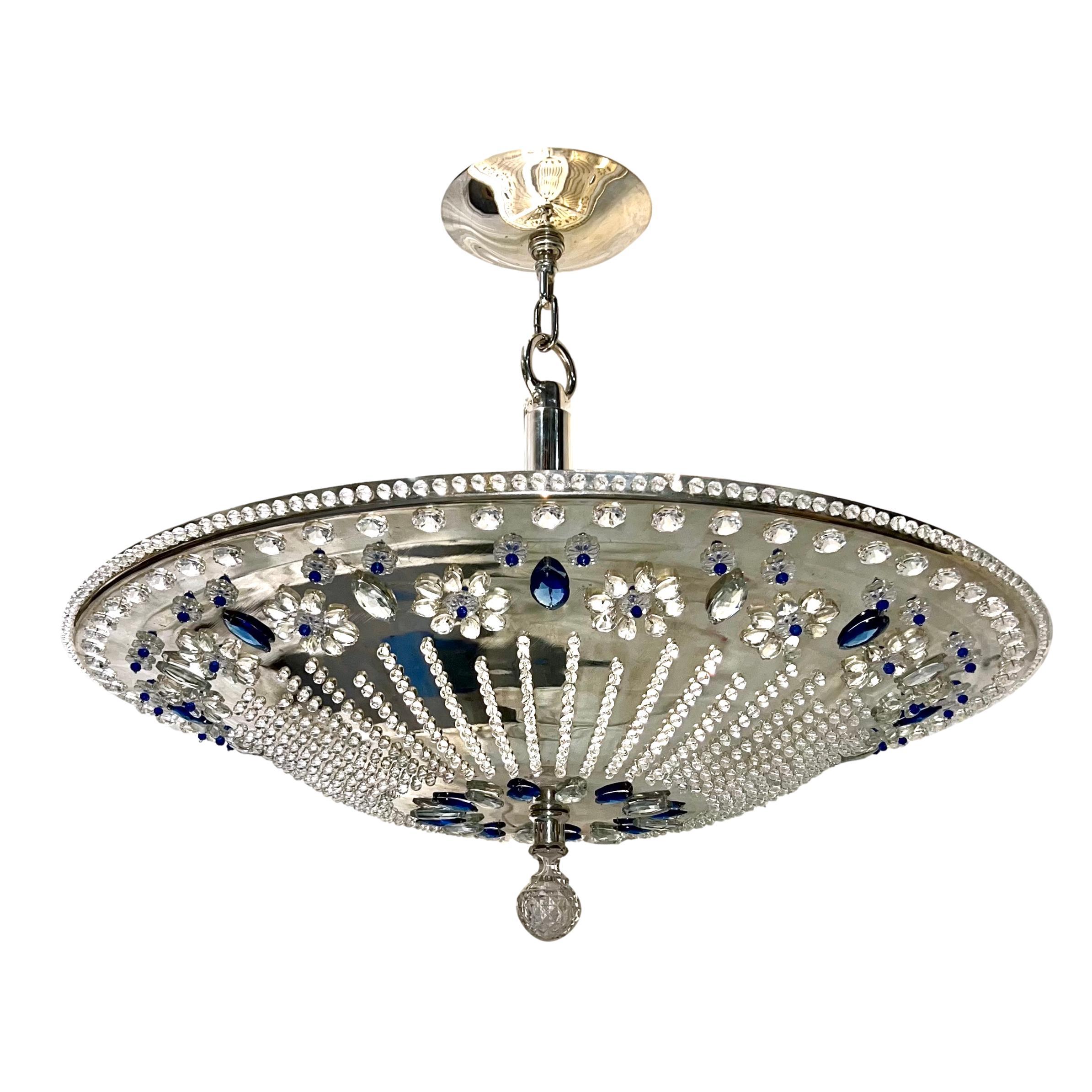 A late 1960's French silver plated light fixture with blue and clear crystal insets and eight interior Edison lights.

Measurements:
Drop: 31