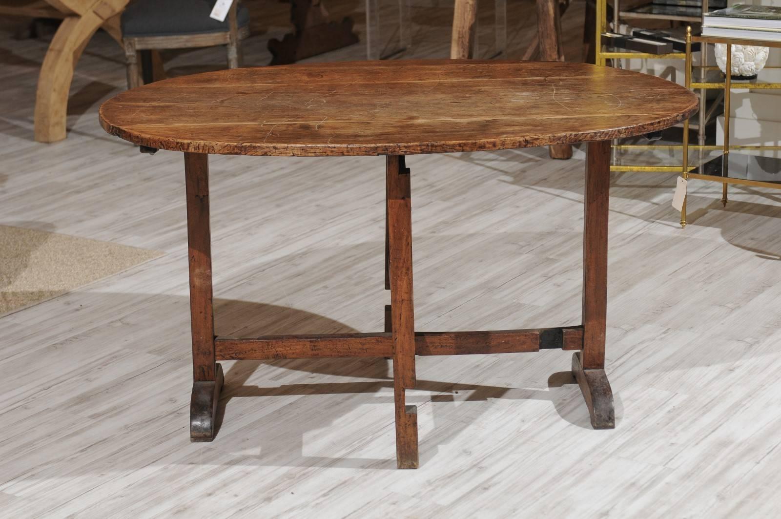 A French oval-shaped tilt-top wine tasting gate leg table from the 19th century. When you're a Francophile like we are, you can't ever have too many wine tasting tables. This one has seen plenty of action over the years and doesn't disappoint with