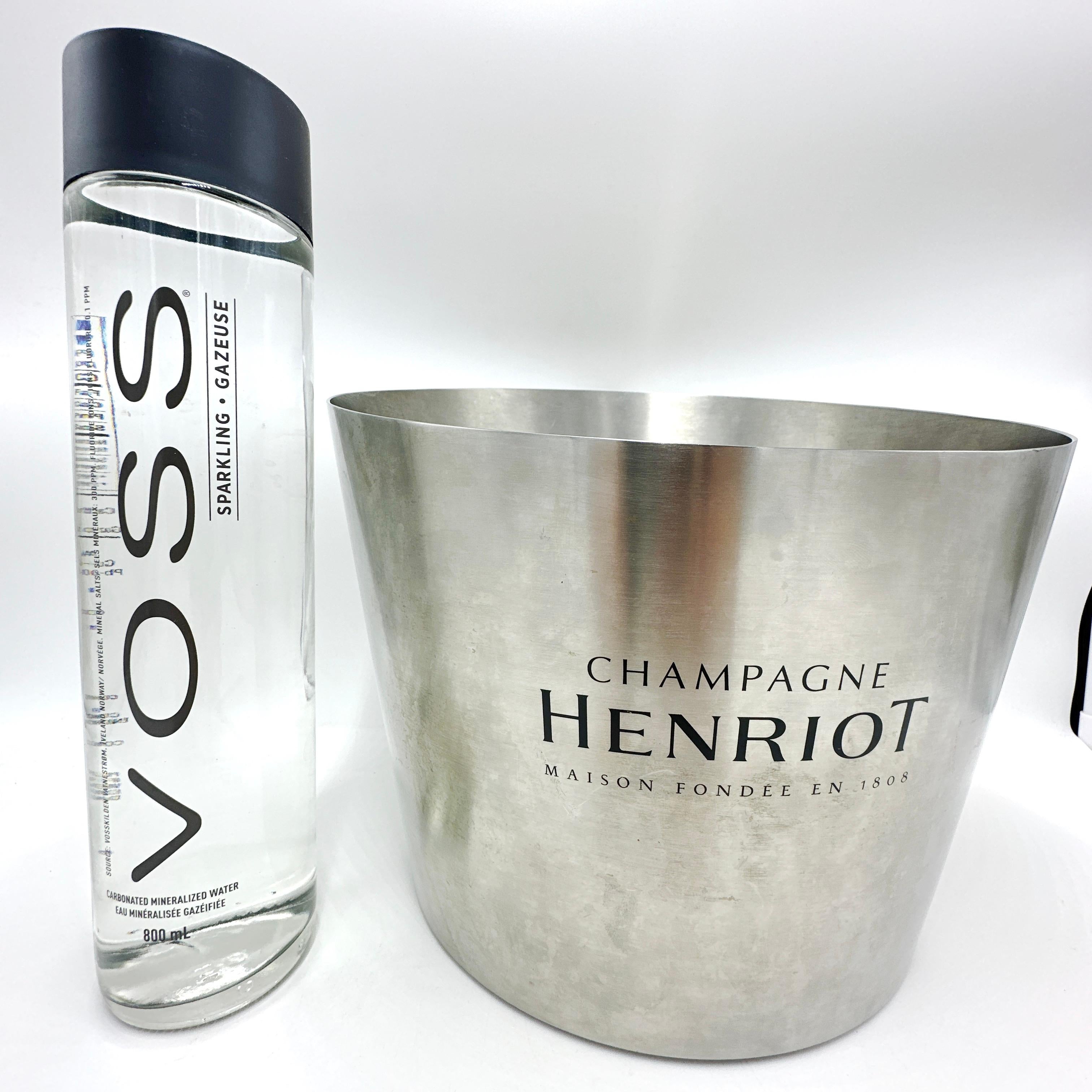 Here is a lovely and Large French Vintage Champagne Henriot Multi Bottle/Magnum Metal Champagne Bucket.

This bucket features the “Champagne Henriot” logo imprinted on the front of the champagne bucket. Made of metal, this bucket is a solid piece