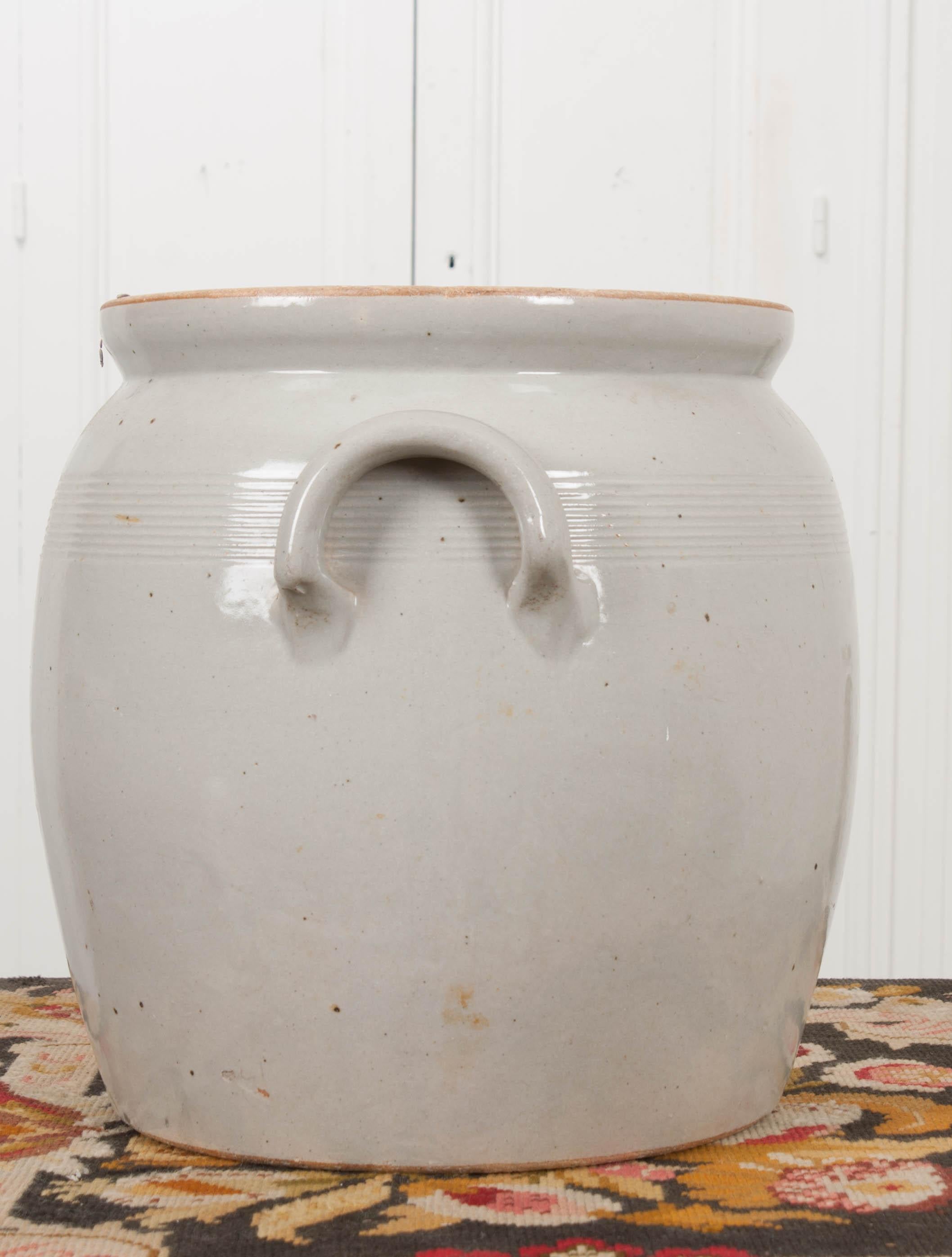 This vintage Provincial ecru-glazed earthenware two-handled crock, circa 1930s is from France and would be perfect for displaying dried flowers or with a collection of other crockery.
