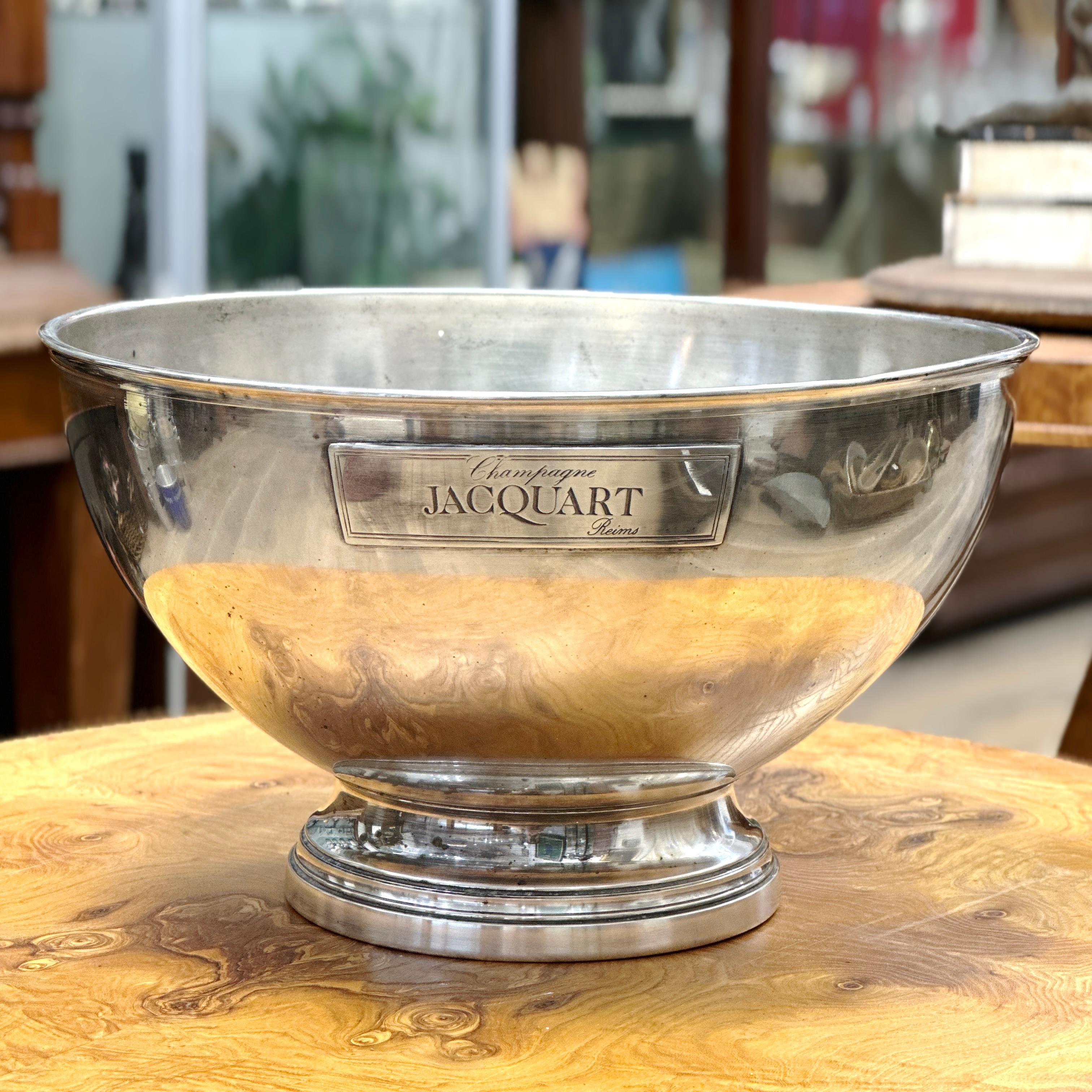 Here is a beautiful and Large French Vintage JACQUART Reims Silver Plated Champagne Bucket. 

This large mid century French silver plated hotel champagne bucket circa 1960s, features an engraved label on both sides stating “CHAMPAGNE JACQUART REIMS”