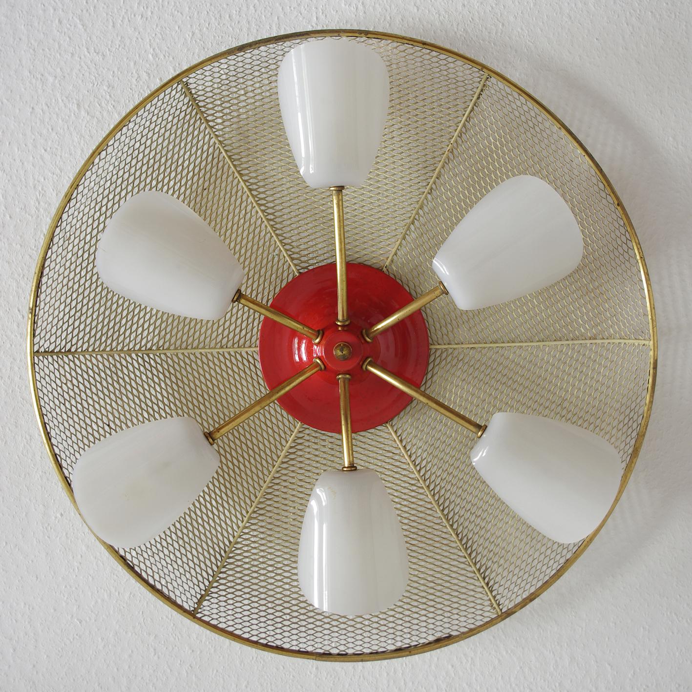 Wonderful mid-century flush mount attributed to Mathieu Matégot.
France, 1950s.
Perforated, enameled metal shield with brass and Lucite.
Lamp sockets: 6.