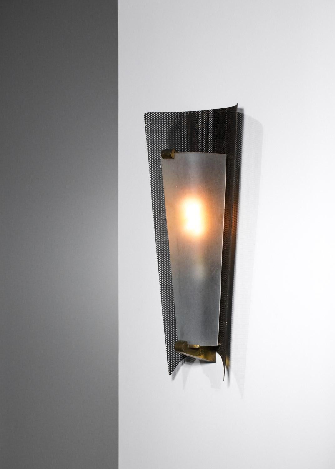 Beautiful wall lamp in the style of Mathieu Mategot's work from the 50's. Structure in black lacquered rigitulle (original paint) and gilded wrought iron, diffuser in opaque Plexiglas. Very nice vintage condition, to note traces of time and use on