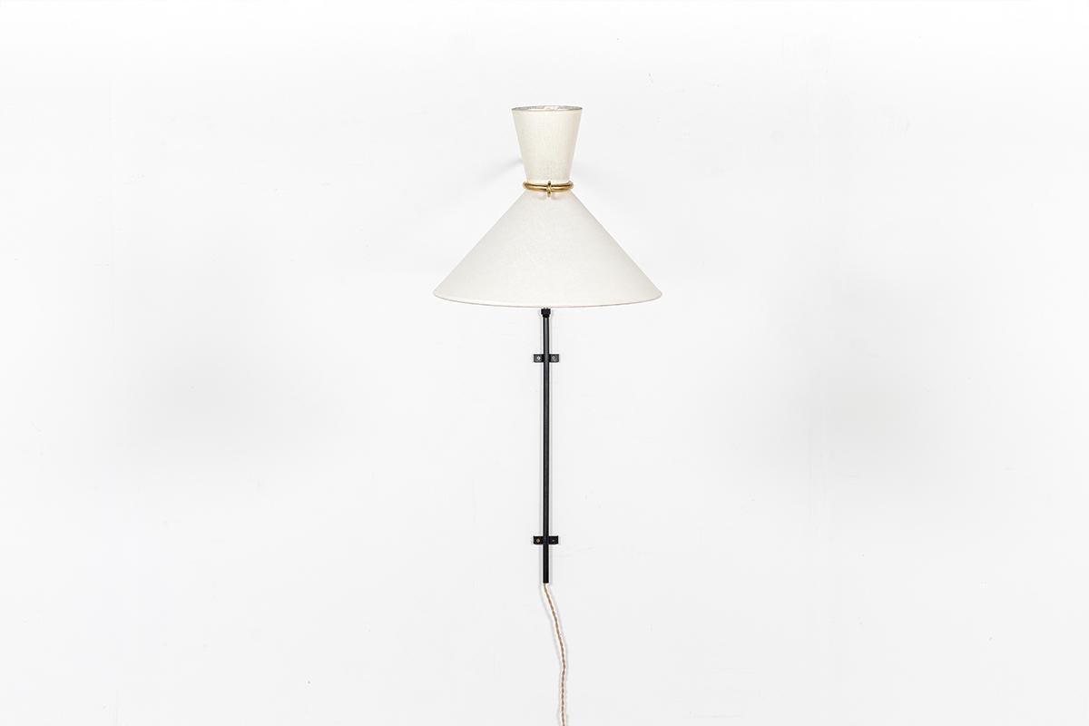 Very large wall light, manufactured by Lunel (attributed to) famous French company in the 1950. 
Composed of black metal wall base, brass arm and bespoke beige paper diabolo lampshade. 
Thank to the wall base, you can move the arm at 180°.