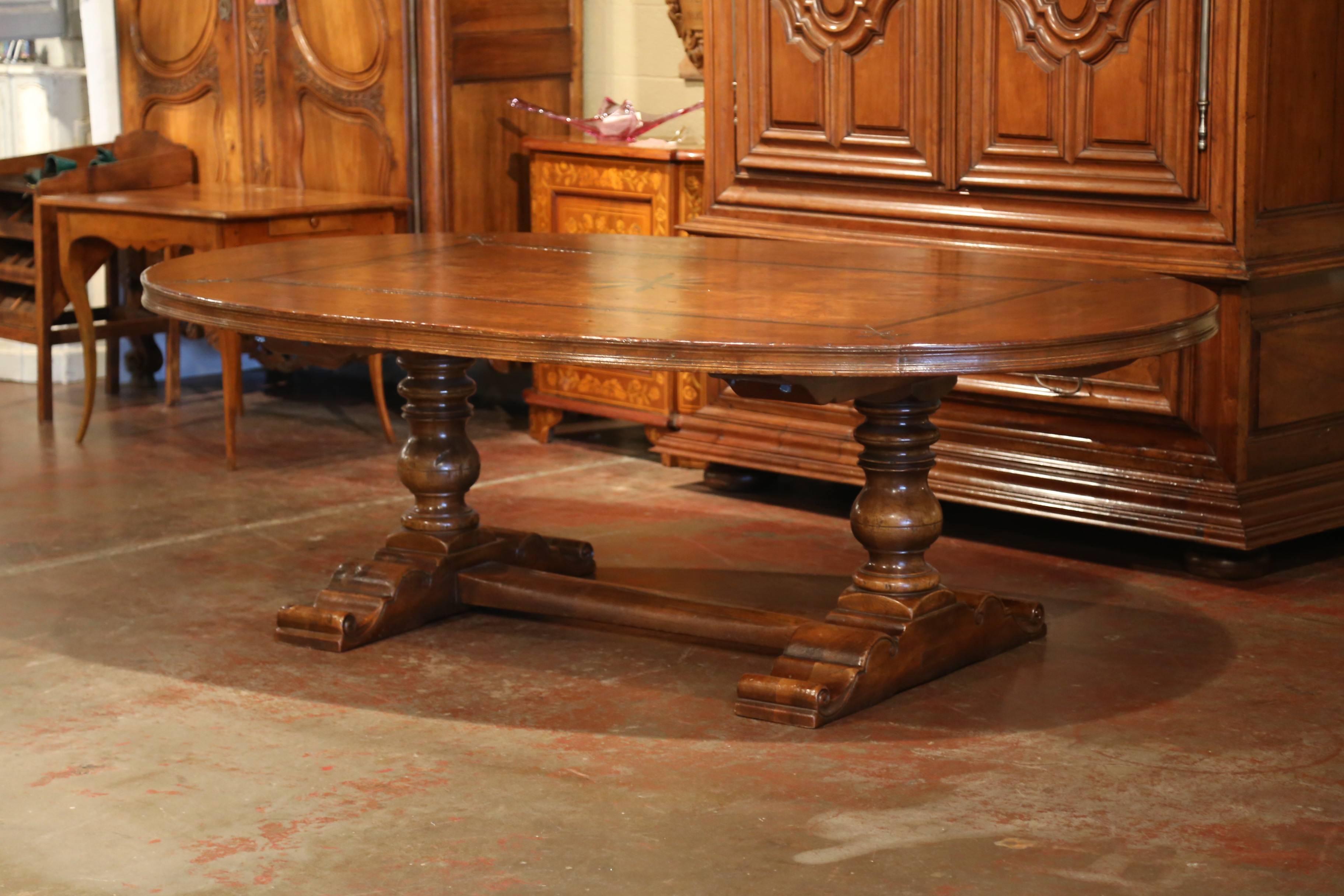 This elegant and large fruitwood table was crafted in the Pyrenees Mountains of France using 18th century wood; the table was crafted using different types of luxurious wood: walnut, chestnut, burl walnut and ebony. The oval surface of the table