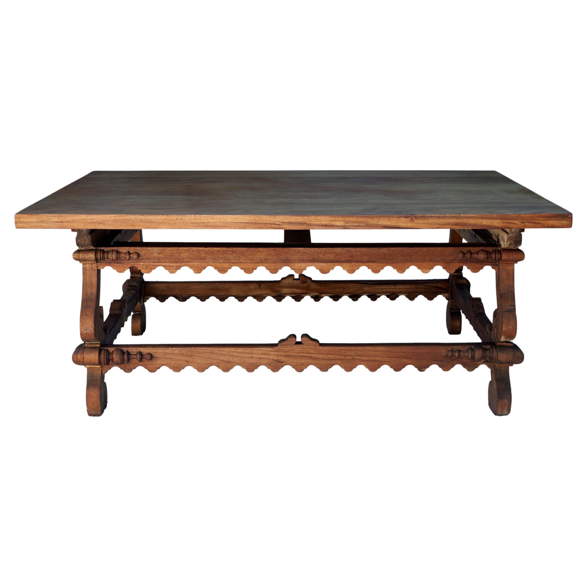 Stunning European rectangular centre table. The removable top sits on inverted legs joined by a box stretcher with a serrated edge. The base has decorative trim on each corner.