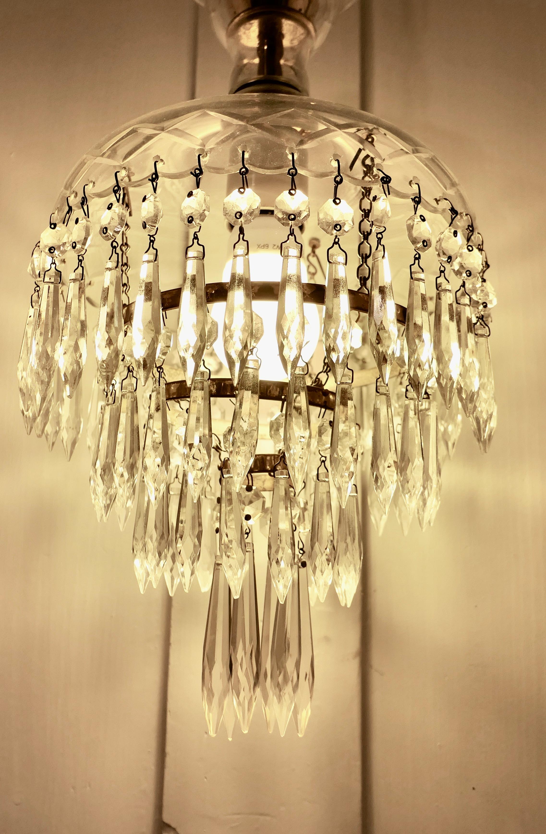 Large French Waterfall Crystal Chandelier

This is a very pretty crystal chandelier, the top has an etched Glass Dome  
The hanging waterfall is suspended from the glass crown with chains of crystal beads, this piece is very attractive when lit 
The