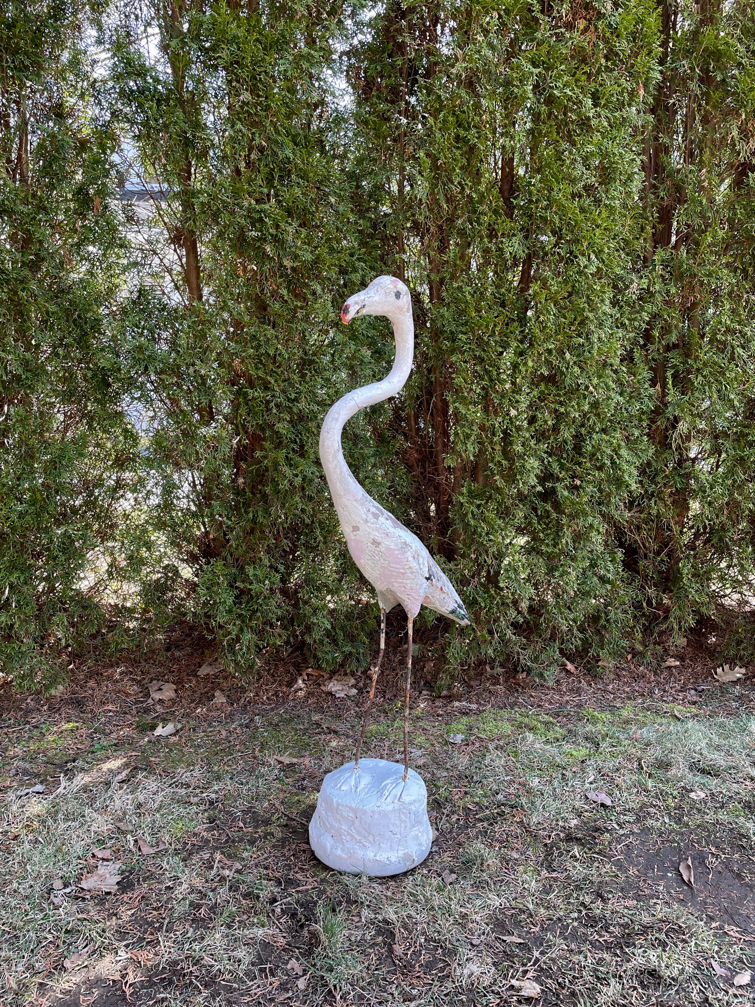 We jumped at the chance to buy this grouping of three French flamingos and this is the white flamingo with an orange/red beak. Made of cast stone with iron legs, and very solid, he cuts a dashing figure, and has a beautifully-weathered and crusty
