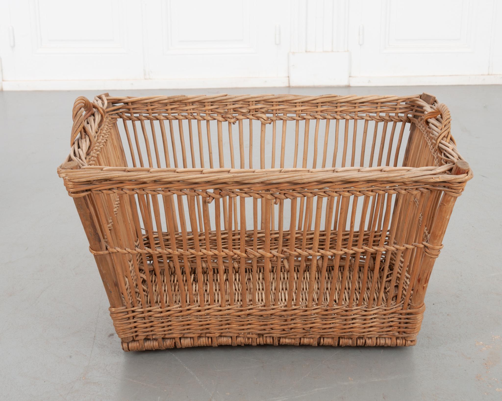 This handwoven wicker basket is as functional as it is beautiful. This basket shows off a cage-like style of weaving in the walls and base for a nice open view of the basket. Great for storing blankets! Make sure to view the detailed images for a